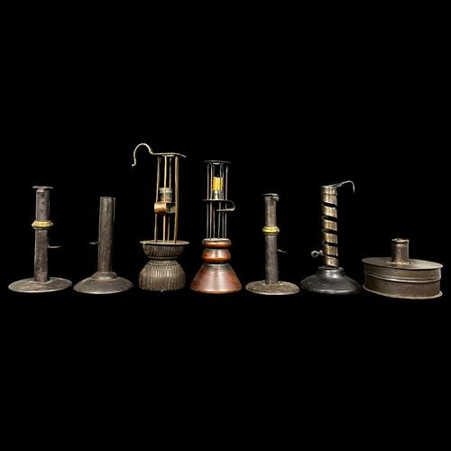 Lot of 7 Antique Primitive Metal Candlesticks and Chambersticks: Assorted lot of seven antique metal candleholders in a variety of unusual forms, including push-up candlesticks, cage-form examples with turned wood and metal bases, a spiral adjustable holder, and a 