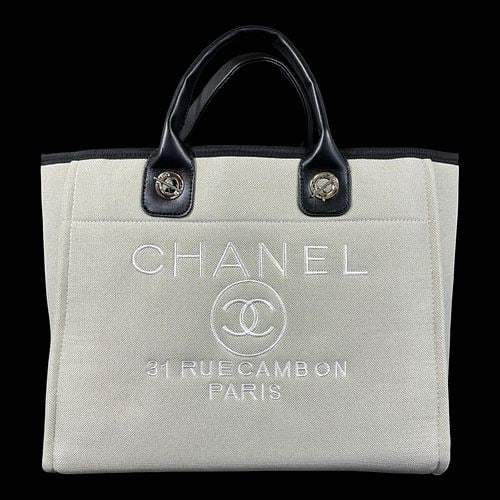 Chanel 31 Rue Cambon Canvas & Leather Tote Handbag Apricot/Black: Chanel canvas tote handbag featuring the iconic embroidered "CHANEL 31 RUE CAMBON PARIS" logo on the front in the Apricot colorway with black leather top handles, silver-tone chain shoulder 