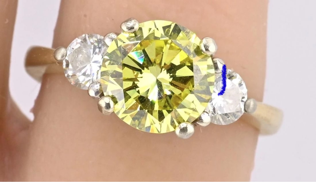 GIA Certified 1.99ct Fancy Intense Yellow Diamond Ring VS1, .50 ct Side Diamonds: GIA Certified 1.99ct Fancy Intense Yellow Diamond Ring VS1, .50ct Side Diamonds, 14K GoldDescription:This exquisite GIA-certified diamond ring features a stunning 1.99 carat fancy intense yellow diamo