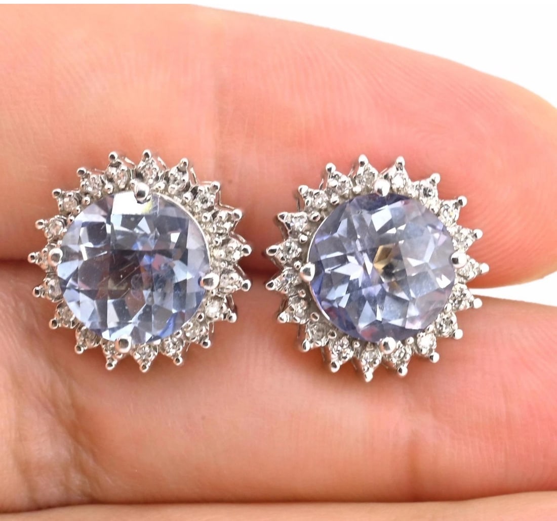 Natural Blue Topaz Diamond Halo Earrings in 14K White Gold IGI Certified: Experience the vibrant sparkle of natural blue topaz in these elegant halo earrings. The pair features two round-cut genuine blue topaz gemstones (~9.95 x 10.10 mm each) with a combined weight of appr