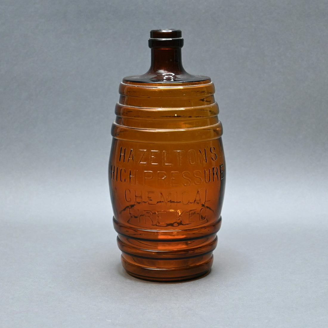 Hazelton's Amber Glass Chemical Fire Keg: Hazelton's Chemical Fire Keg Molded Amber Glass Bottle. Height 11 1/4 Inches.