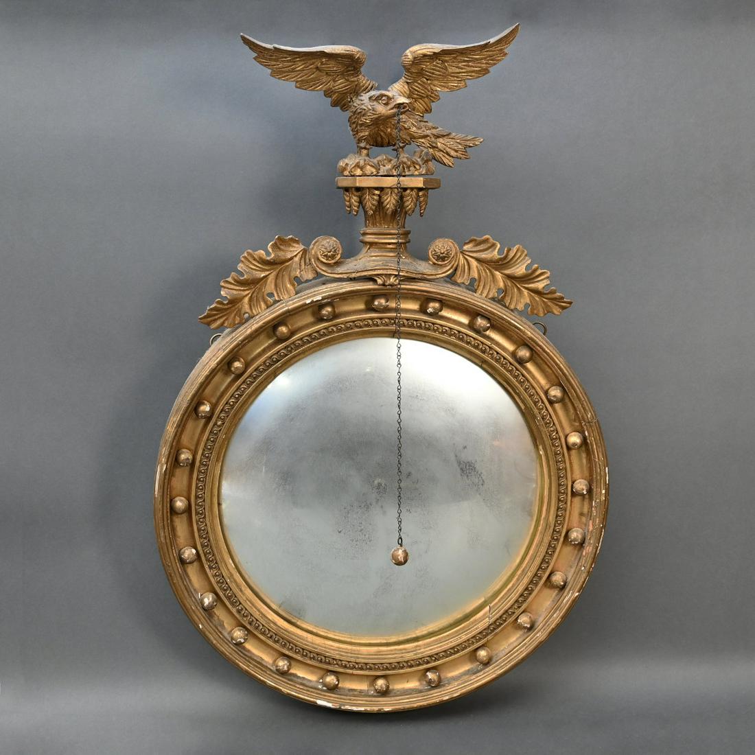 Classical Carved Giltwood Convex Mirror: Classical Carved Giltwood Convex Mirror. The Round Mirror Plate Surrounded By A Carved And Molded Liner With Applied Balls, Surmounted By A Spreadwing Eagle On Plinth With Acanthus Leaf Decorated And