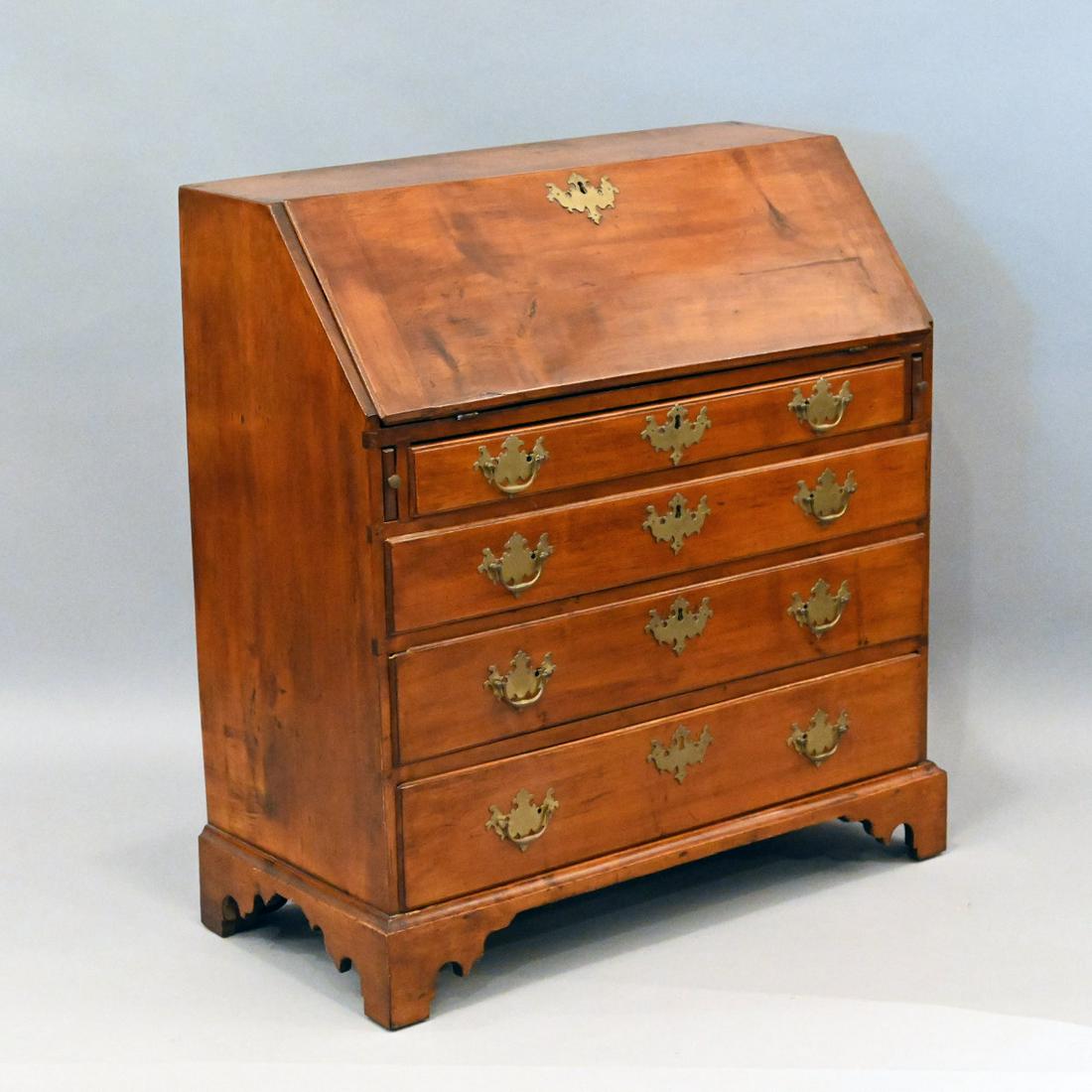 New England Chippendale Maple Slant Front Desk: New England Chippendale Maple Slant Front Desk. The Oblong Hinged Top Opening To A Stepped Interior With Central Fan Carved Drawer Over Two Conforming Short Drawers, Flanked By Two Pairs Of Short Draw