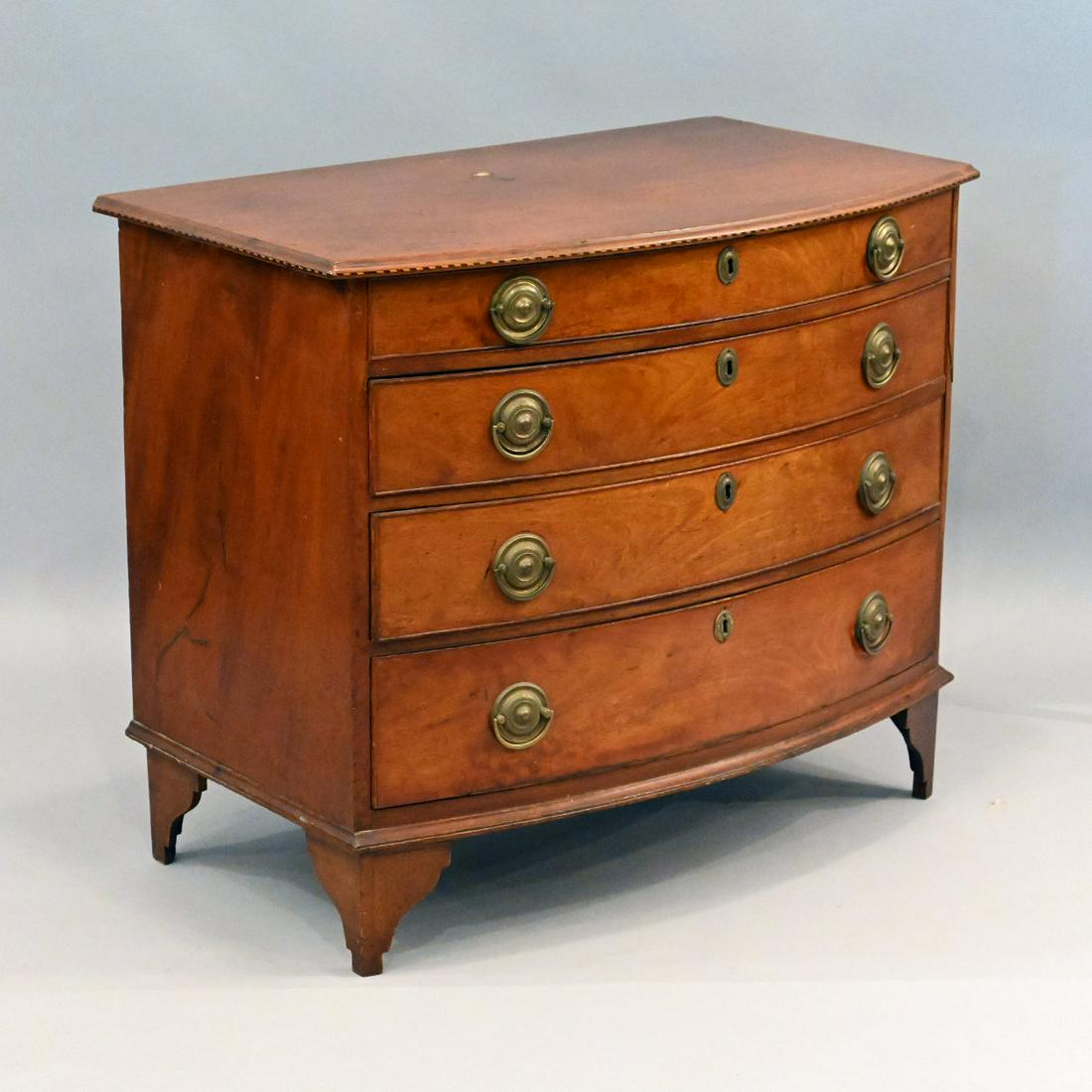 New England Federal Inlaid Mahogany Chest: New England Federal Inlaid Mahogany Bowfront Chest. The Oblong Top With Bowed And Inlaid Molded Edge Above A Conforming Case Of Four Long Drawers, Raised On Later Stylized French Feet. Height 31; Widt