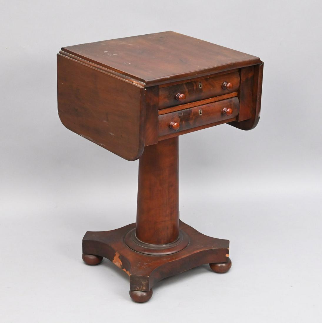 American Empire Mahogany Work Table: American Empire Mahogany Two-drawer Work Table. The Square Top With Hinged Leaves, Above A Case Of Two Drawers, Upon On A Tapered Pedestal On Plinth Base, Raised On Compressed Ball Feet. Height 28; Wi