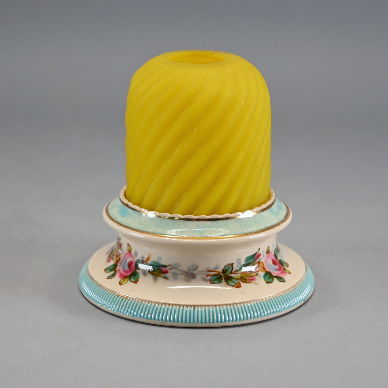 S. Clarke's Pyramid Fairy Lamp: The pyramid size yellow twist ribbed dome with satin finish upon a porcelain lamp cup base with hand-painted floral decoration and sky blue borders bearing the mark of Taylor, Tunncliffe & Co. and dec