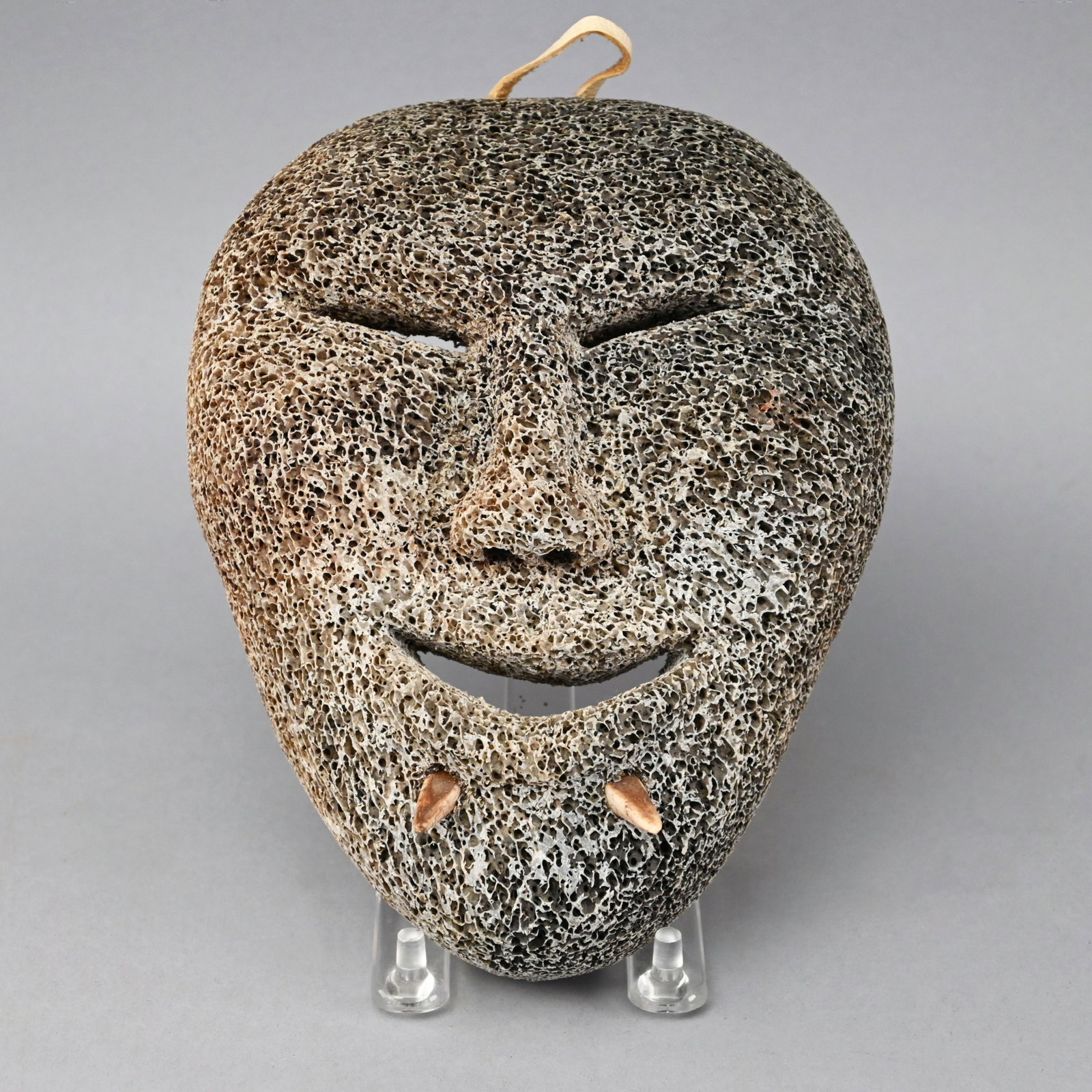 Inuit Whale Bone Spirit Mask: Pierced carved with applied chin spurs. H: 7 in., W: 5.5 in., D: 2.5 in.