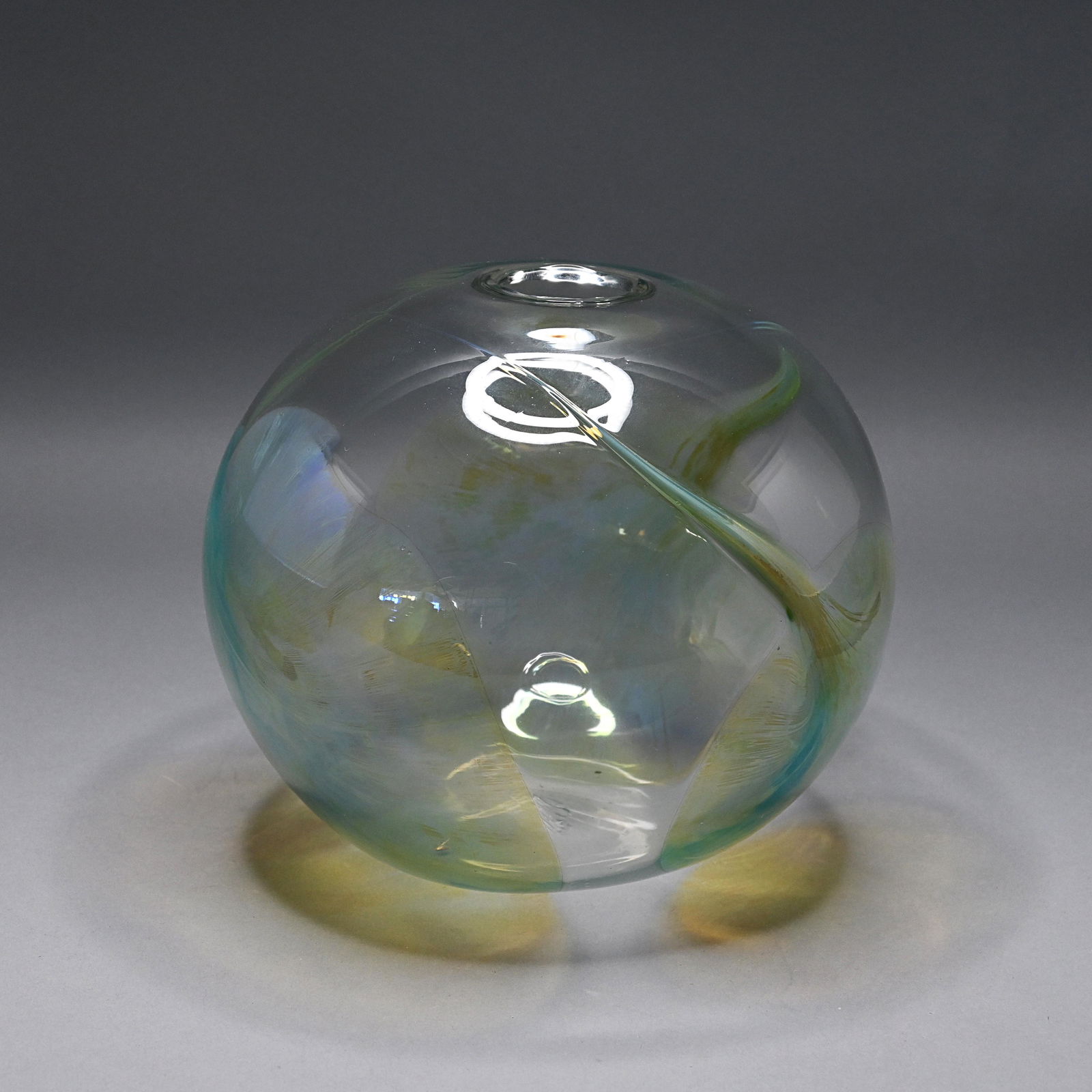 Peter Bramhall (American, b.1942) Art Glass Vase: Of spherical form, decorated on the round with a trio of aqua/amber repeating splotches, dated March 13, 1984. H: 8 in., W: 8 in., D: 8 in.