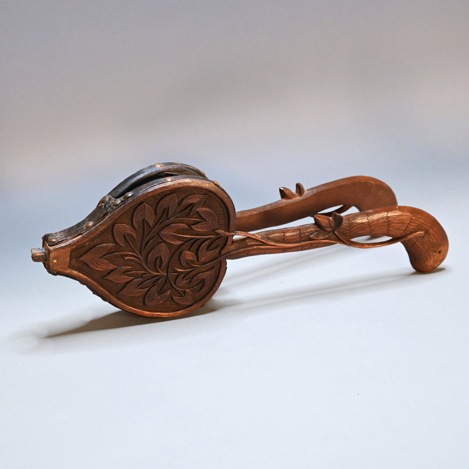Pair of Black Forest Carved Walnut Bellows: The carved pistol grip handles with stylized foliate and vine ornamentation. H: 6 in.; W: 17 in.; D: 1.5 in.