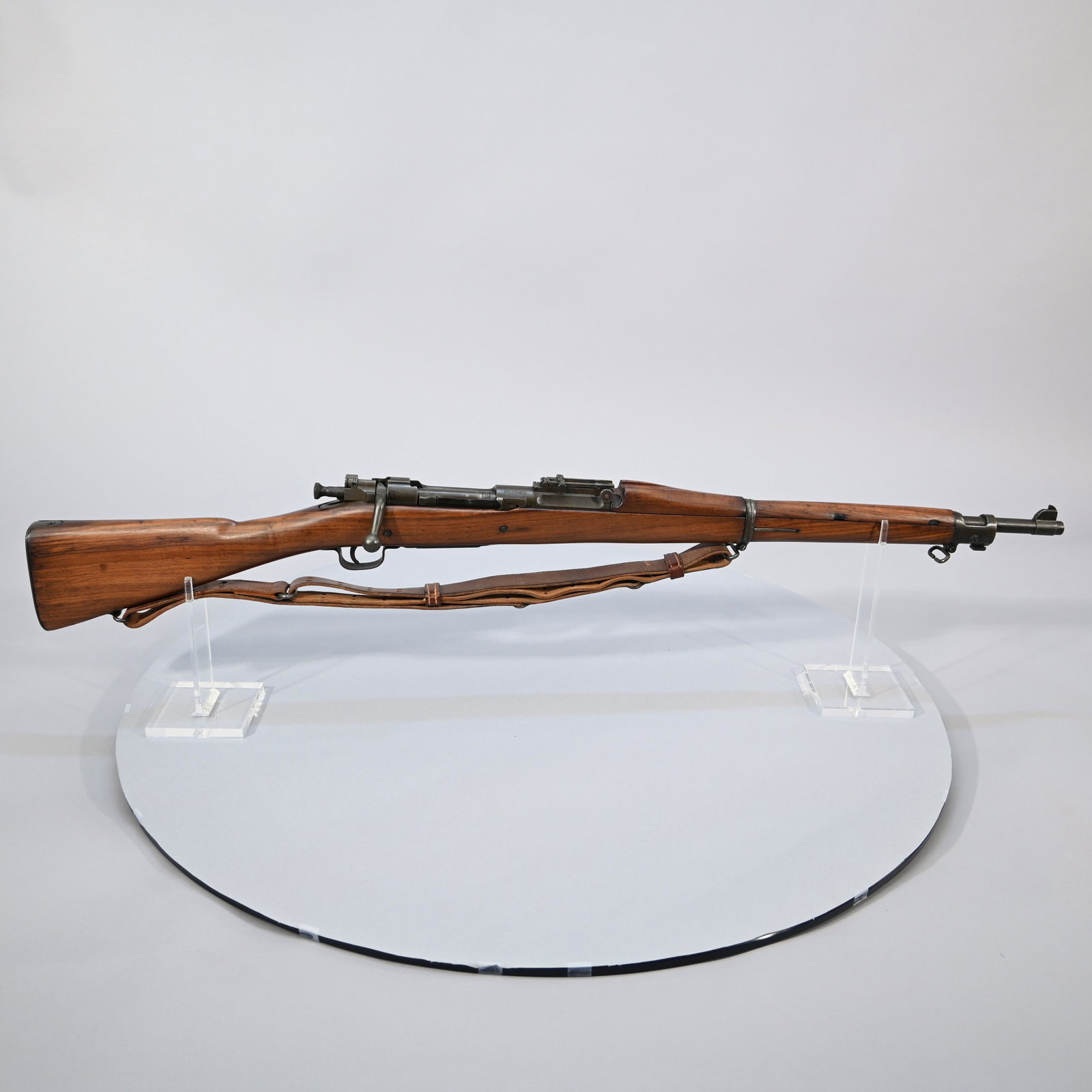 US Springfield Model 1903 Bolt-Action Rifle: Caliber: .30-06, #782540 (1918), with leather sling. Barrel marked "SA" over flaming bomb with "1-18". Barrel length: 23.5 inches. Overall length: 43.5 inches.