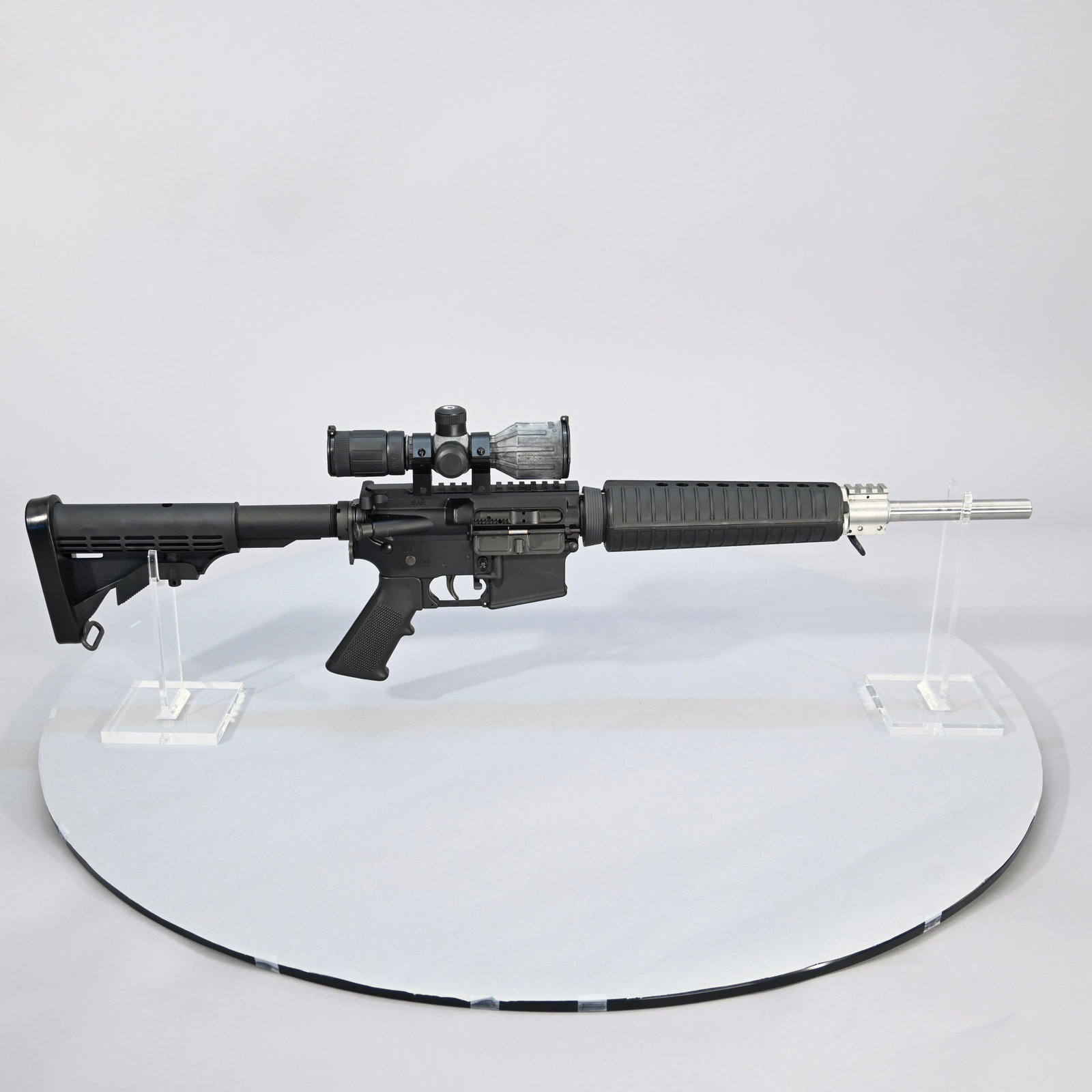 ArmaLite M15 Model Semi-automatic Rifle: Cal. 5.56 x 45mm, stainless steel barrel, telescopic stock, fitted with Barska 3-9x scope. #US343406. Barrel length: 16 inches. Overall length: 34.5 inches (stock extended); 31.25 inches (stock retrac