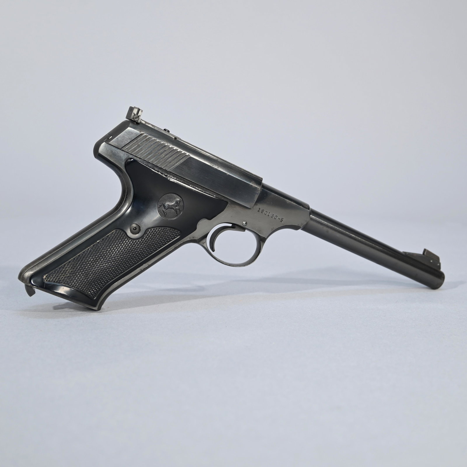 Colt Woodsman Third Series Target Model Pistol: Early 1955 3rd Series model; #160130-S; semiautomatic pistol chambered in .22LR; molded hard black plastic grips; one magazine and leather holster included. Barrel length: 6 inches. Overall length: 10