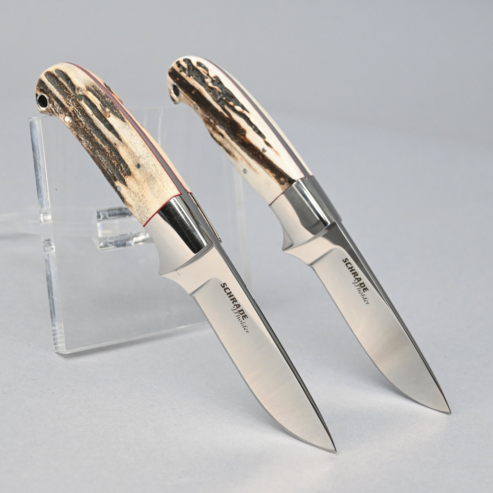 Pair of Schrade D'Holder Custom Hunter Knives: Fixed blade with tapered full length tang and stag handles. Includes leather sheaths and carrying cases. Blade length: 3.75 inches. Overall length: 8 inches.