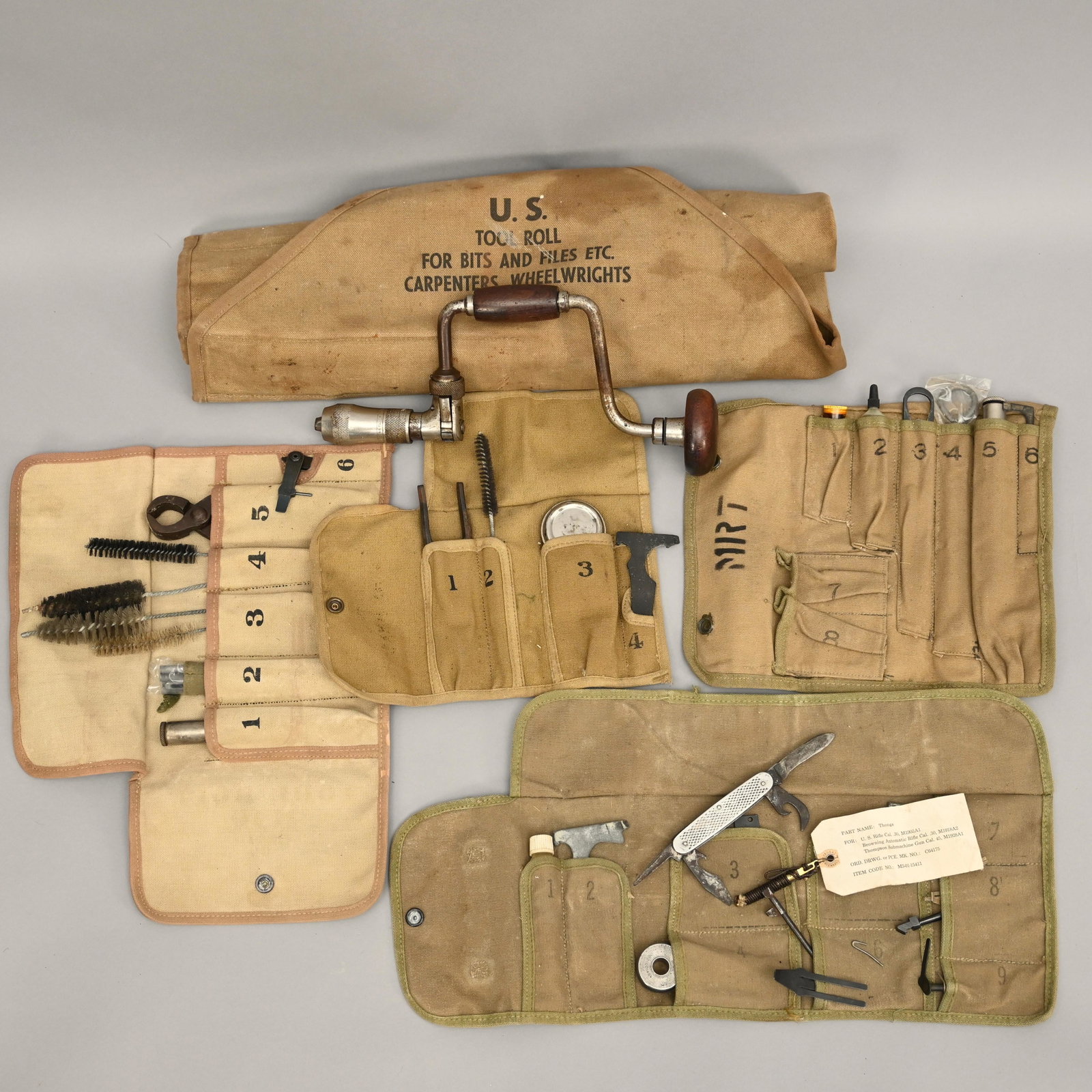 Lot of Assorted US Military Canvas Tool Rolls: Includes the following: - US tool roll with bits & files, carpenters & wheelwrights - M13, M10, M12, & M14 tool rolls & assorted tooling. H: 5.5 in., W: 21.5 in., D: 5.5 in. (largest)