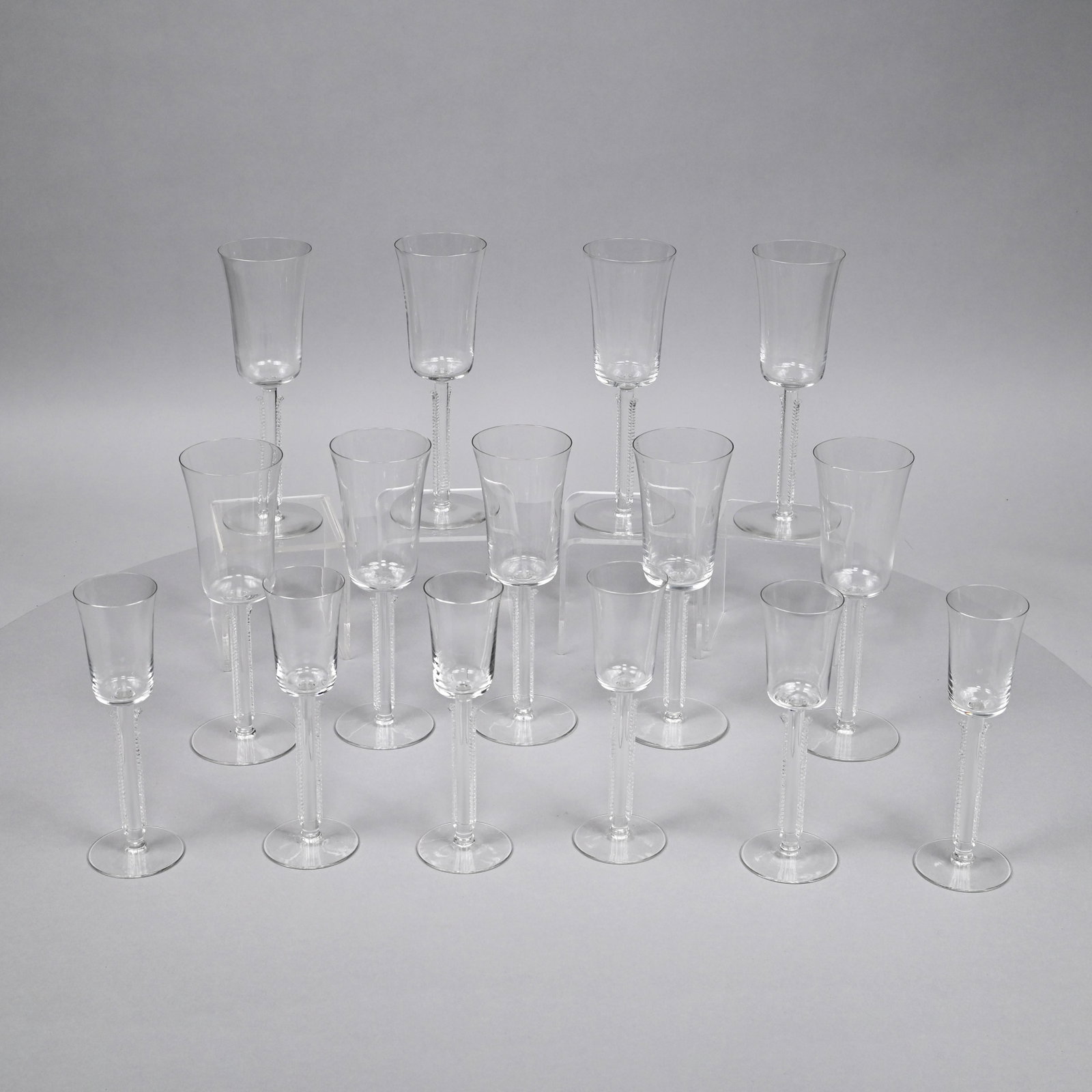 Set Art Deco R. Lalique 'Cannes' Glasses, 1930's: Comprising six cordials and nine red wine glasses, each sandblasted in block letters "R. LALIQUE/ FRANCE" under the foot. Height of red wine stems: 8.625 in. Height of cordials: 7.375 in.