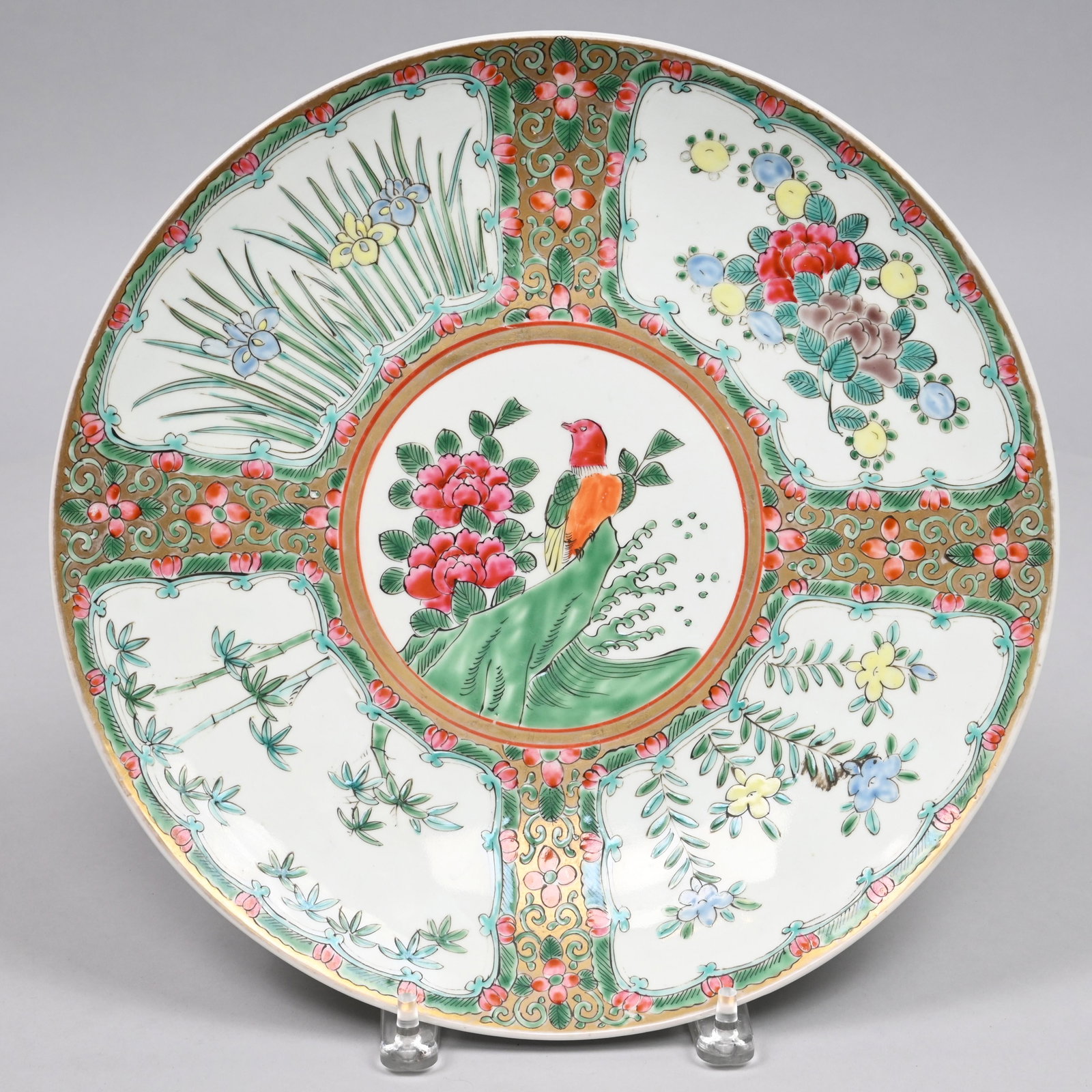 Chinese Export Porcelain Charger, 19th Century: Painted in the center with peonies and a bird perched upon a rock, surrounded by panels of iris, bamboo, asters, and a peony and berry spray, Chenghua six-character mark in underglaze-blue. H: 1.75 in