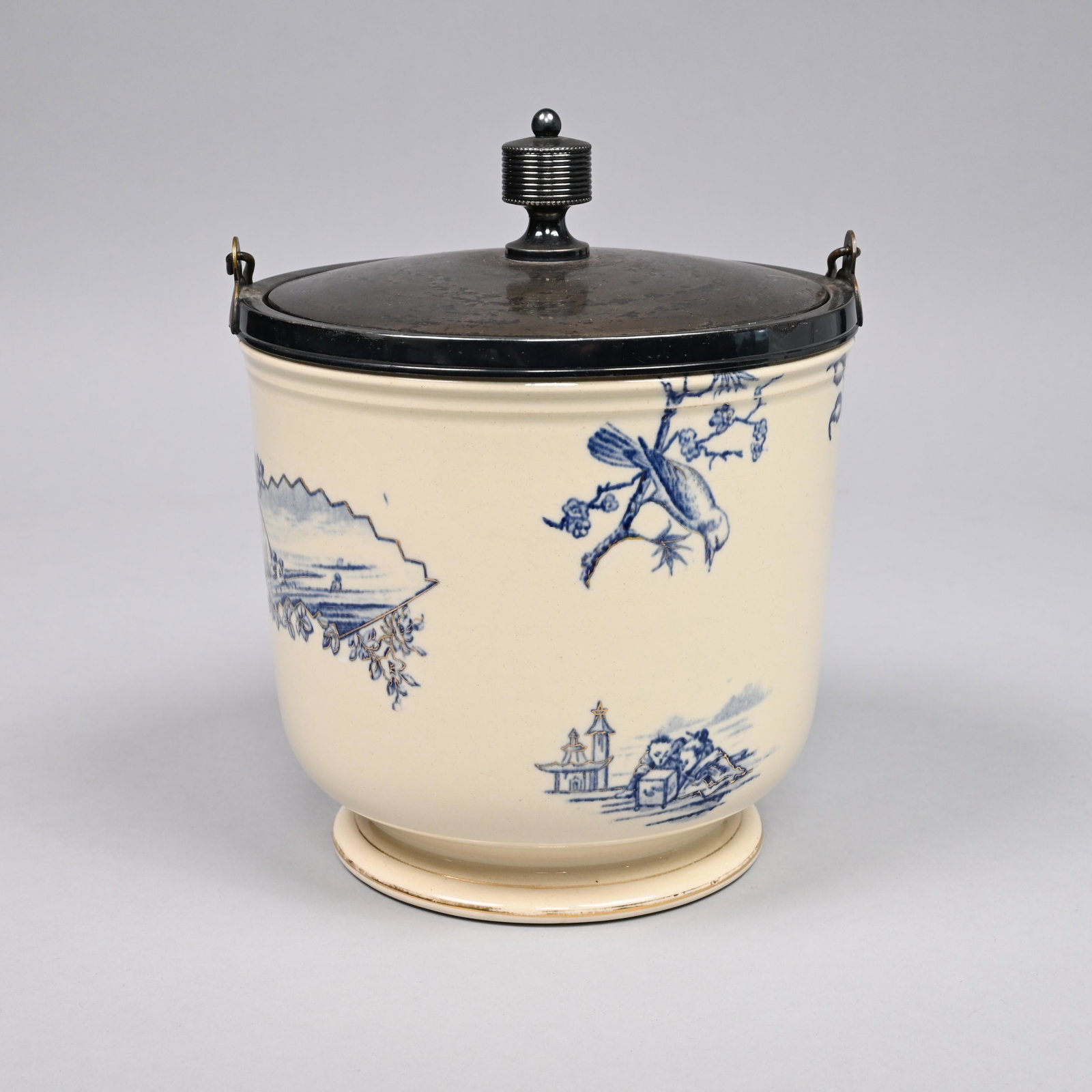 Aesthetic Movement Ice Pail, Late Nineteenth Cen.: Earthenware transfer-printed in blue and gilt-heightened with a songbird observing three fledglings perched underneath an umbrella, a fan-shaped reserve depicting fishermen and a skiff, and a shell an