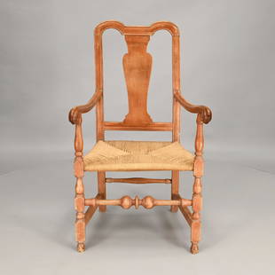 New England Queen Anne Red Painted Armchair: The yoke crest rail above a vasiform splat, flanked by open arms with ram's head terminals with ring and block turned supports, above a rush seat raised on block, ring and ball turned legs joined by