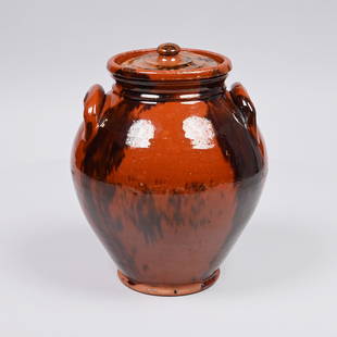 New England Redware Jar with Manganese Stripes: Of ovoid form, the bulbous body with applied handles, decorated in an alternating pattern of full length manganese stripes and splotches above a slightly outset rolled foot, the molded lid within a