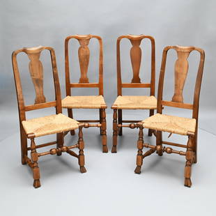 Four New England Queen Anne Spanish Foot Chairs: Each peaked yoked crest rail above a vasiform splat and rush seat, raised on block-and-turned frontal legs joined by a medial stretcher, terminating in Spanish feet. H: 41.5 in.; W: 19 in.; D: 17 in.