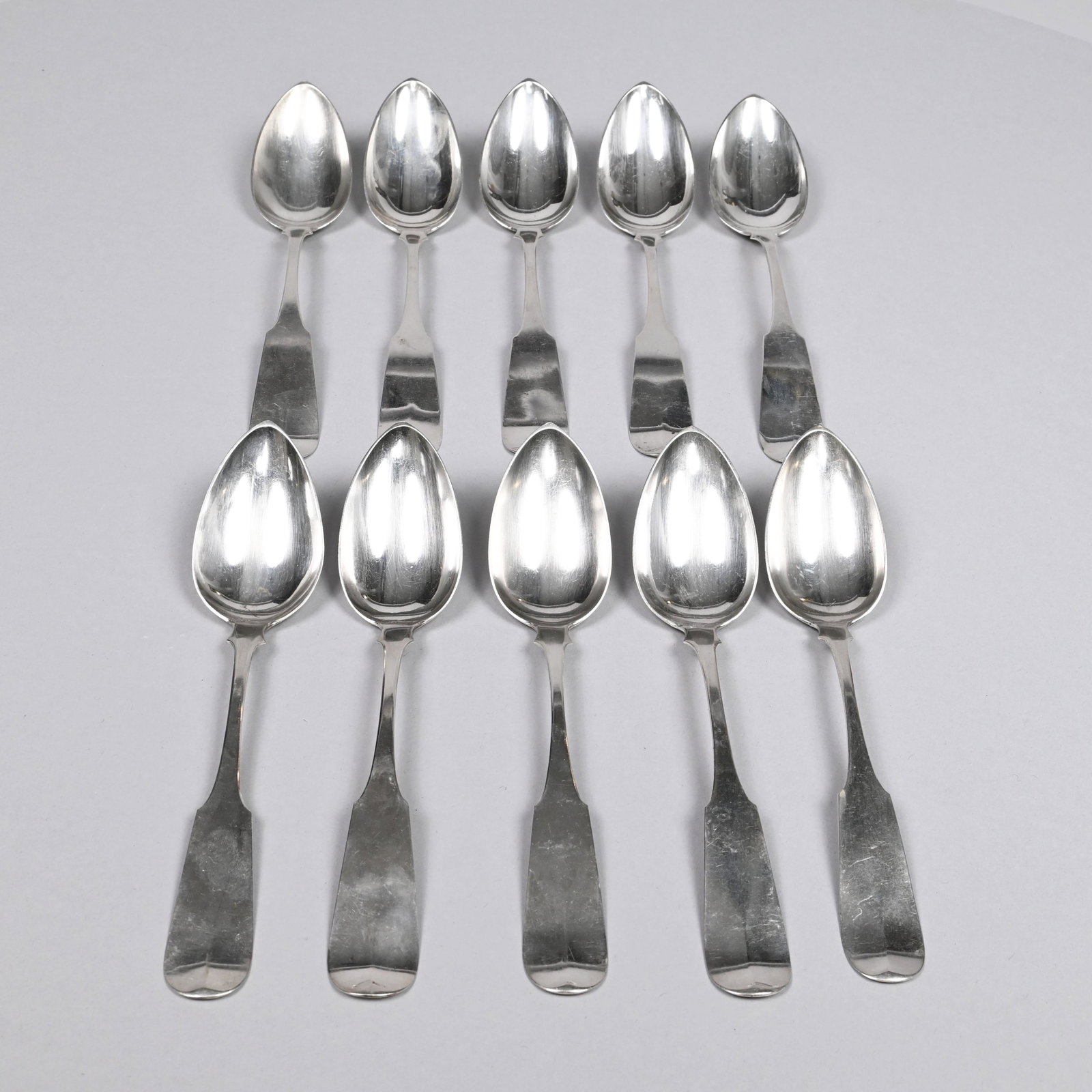 Set of Ten Amer. Silver Tablespoons, Edward Watson: Boston, 1815-39. Each with fiddle handle, chamfered shoulders, pointed oval bowl and shell drop, engraved on the reverse "FER" in foliate script, each marked "E. Watson" into a rectangle. 14.47 troy o