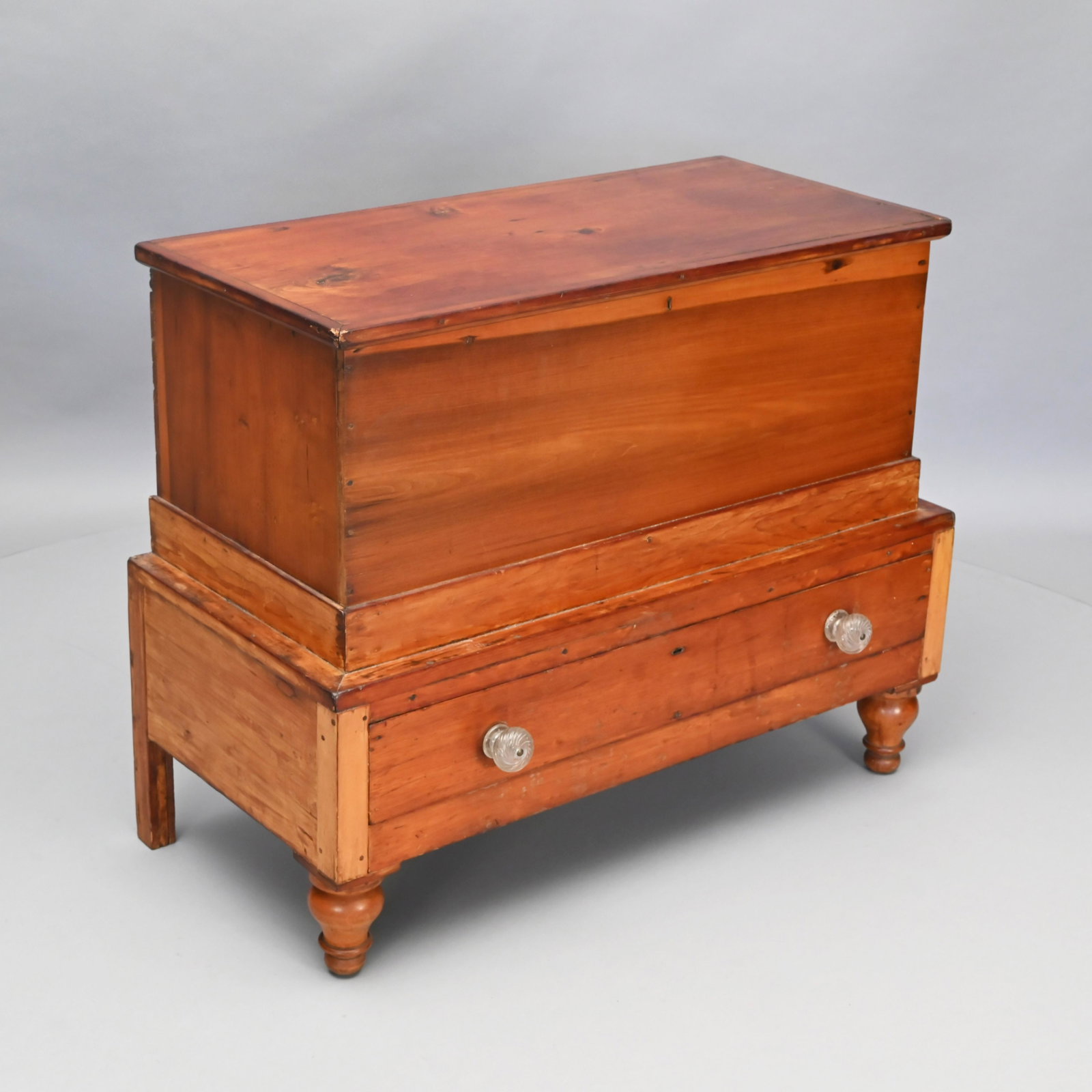American Pine and Poplar Blanket Chest: The rectangular hinged top opening to a well with til, the outset base with single long drawer fitted with blown glass pulls, raised on short turned legs. H: 31 in.; W: 39.5 in.; D: 21 in.