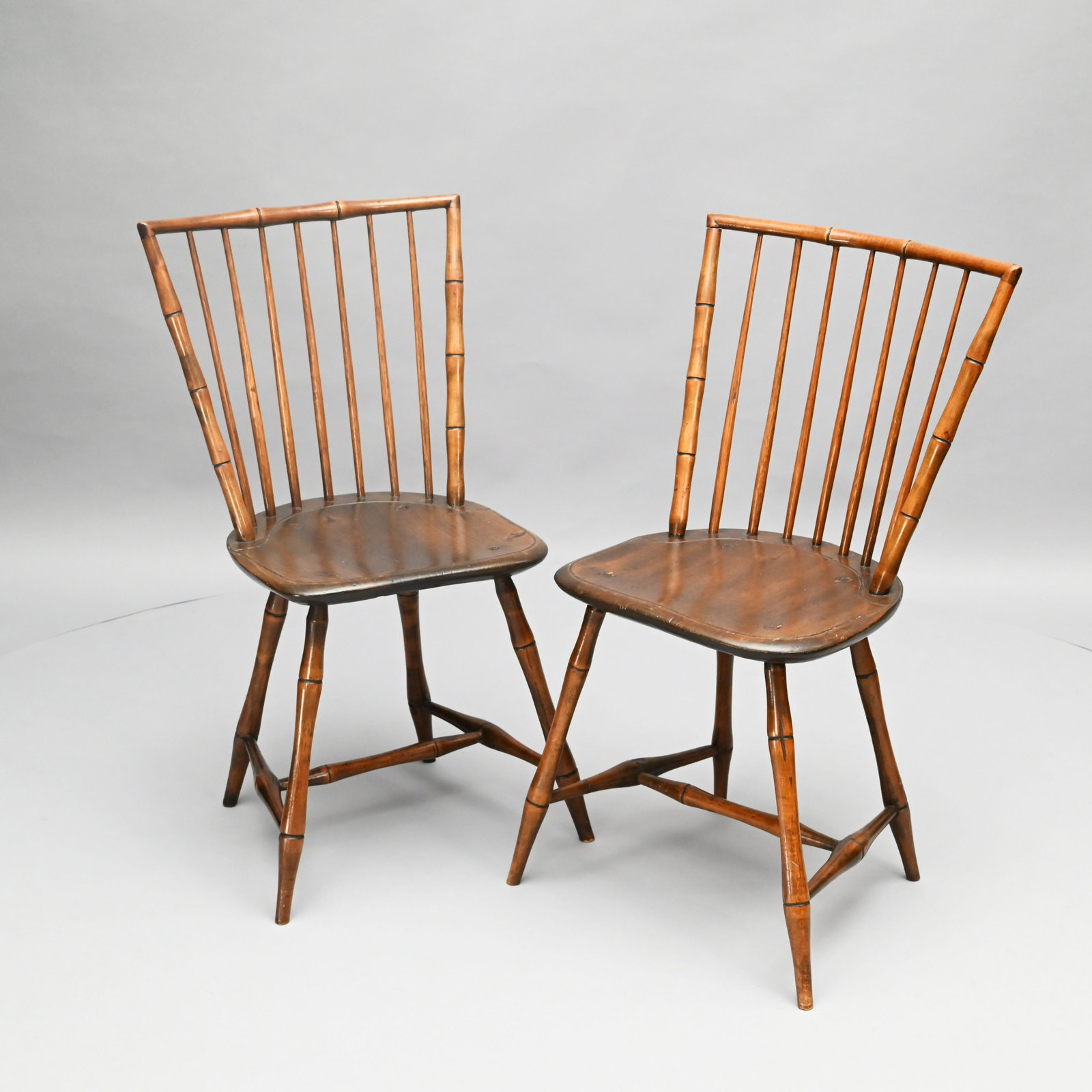 Pair of American Bamboo Turned Rod-Back Windsors: Each with a seven-spindle back, above a plank seat. H: 34 in.; W: 19.5 in.; D: 16 in. (approx.)