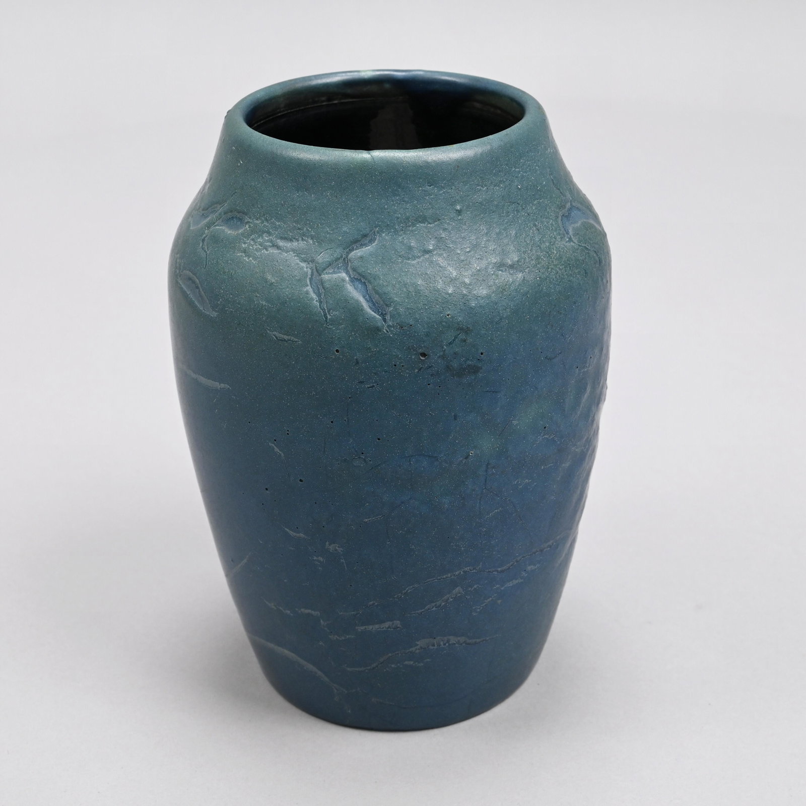 Hampshire Pottery Vase, Cadmon Robertson, 1904-14: Designed by Cadmon Robertson, Keene, New Hampshire, 1904-14. Of high-shouldered tapered cylindrical form, covered in dark matte blue partly curdled glaze, incised "Hampshire Pottery," letters "M" and 