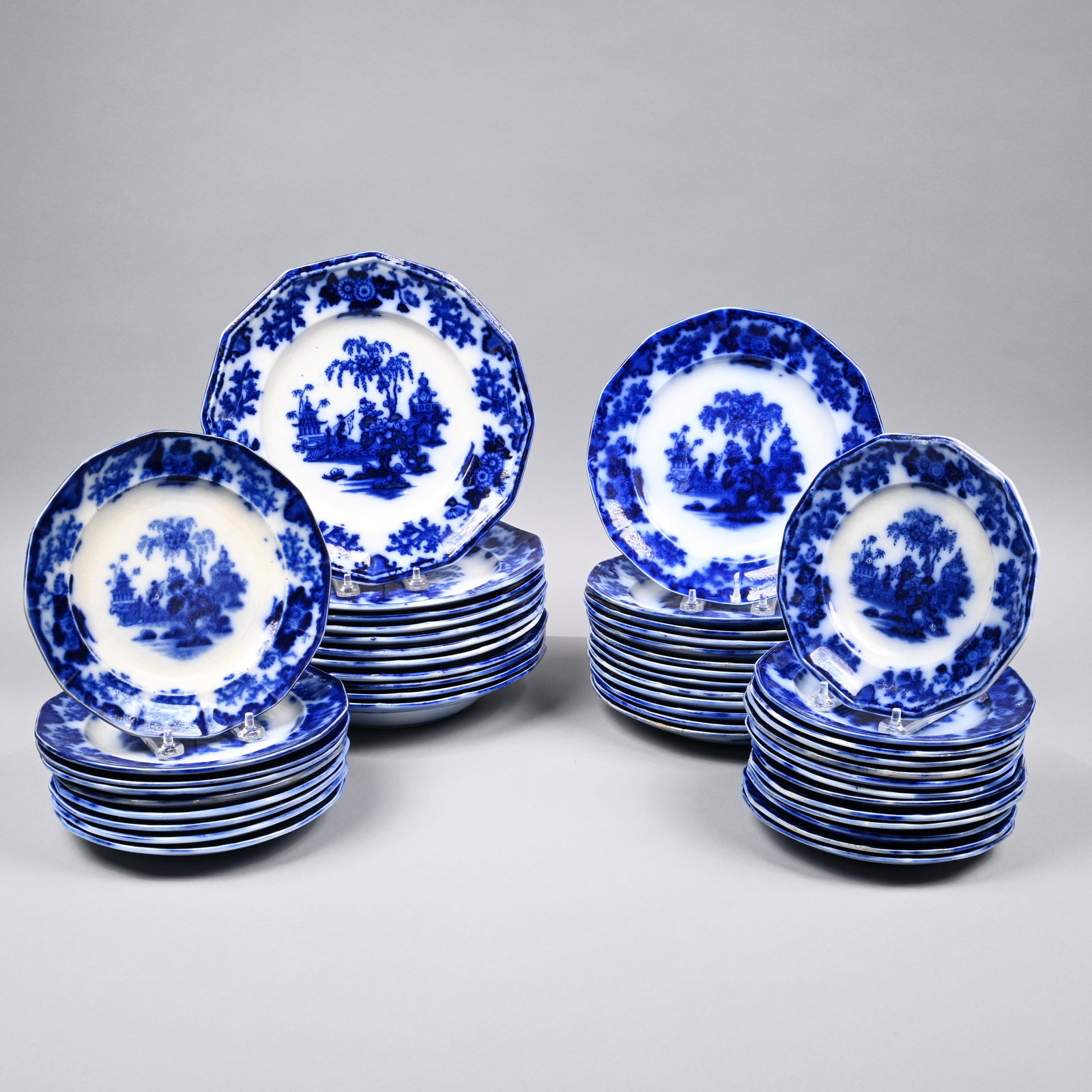 Scinde, Group of Flow Blue Ironstone Plates: 'Scinde,' Group of Staffordshire Flow Blue Ironstone Plates, J. & G. Alcock, Cobridge, 1839-46 and Dimmock & Smith, Circa 1842. Comprising thirteen 7.25- inch plates, five 8- inch plates, four 8.25- i