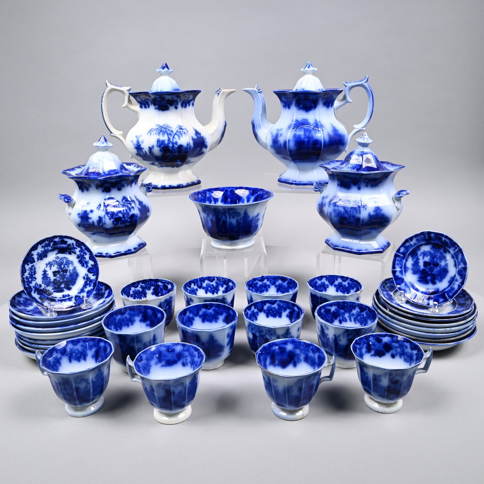 Scinde, Grp. Flow Blue Ironstone Coffee &Tea Wares: 'Scinde,' Group of Staffordshire Flow Blue Ironstone Coffee and Tea Wares, J. & G. Alcock, Cobridge, 1839-46 and Dimmock & Smith, Circa 1842. Comprising two teapots and covers, two sugar bowls and cov