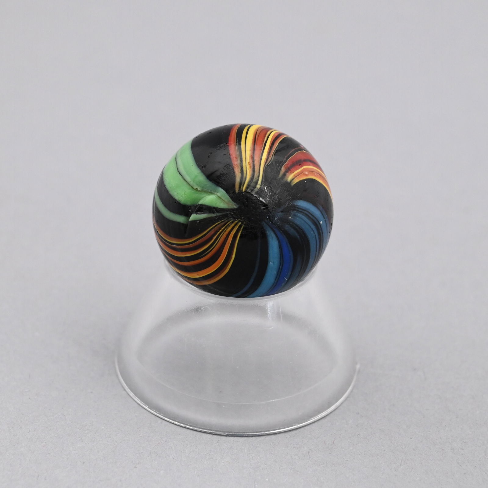 Large Indian Marble: In cobalt black, blue, green, rose, yellow and white swirls. Diam: 115/128 in.