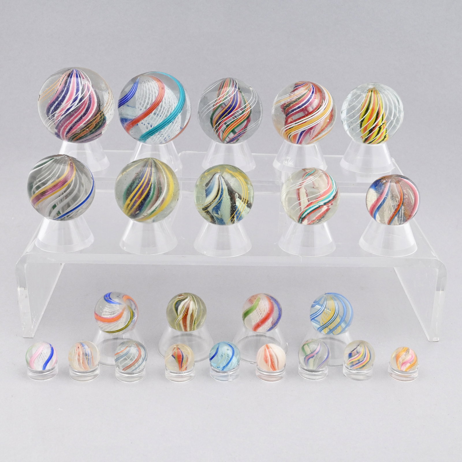 Twenty-Three Handmade Swirl Marbles: Several with a core. Approximate range of diam: 9/16 inch to 1 23/32 in.