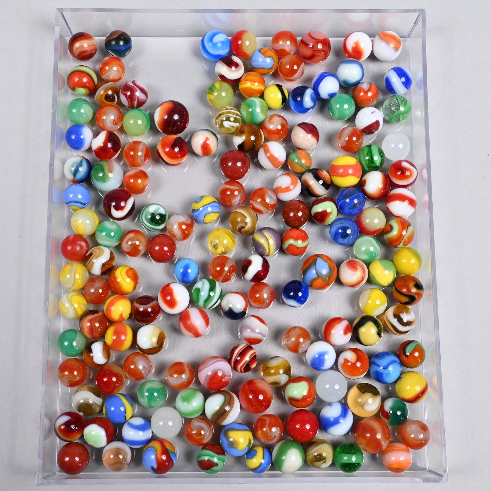 Group of Mixed Machine-Made and Akro Agate Marbles: Approximate range of diam: 73/128 to 51/64 in.