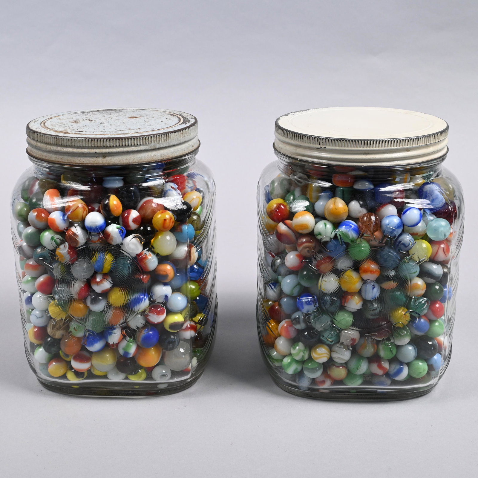 Two Jars of Vintage Assorted Machine-Made Marbles: Tallest jar: H: 8 in., W: 6.25 in., D: 6.25 in.