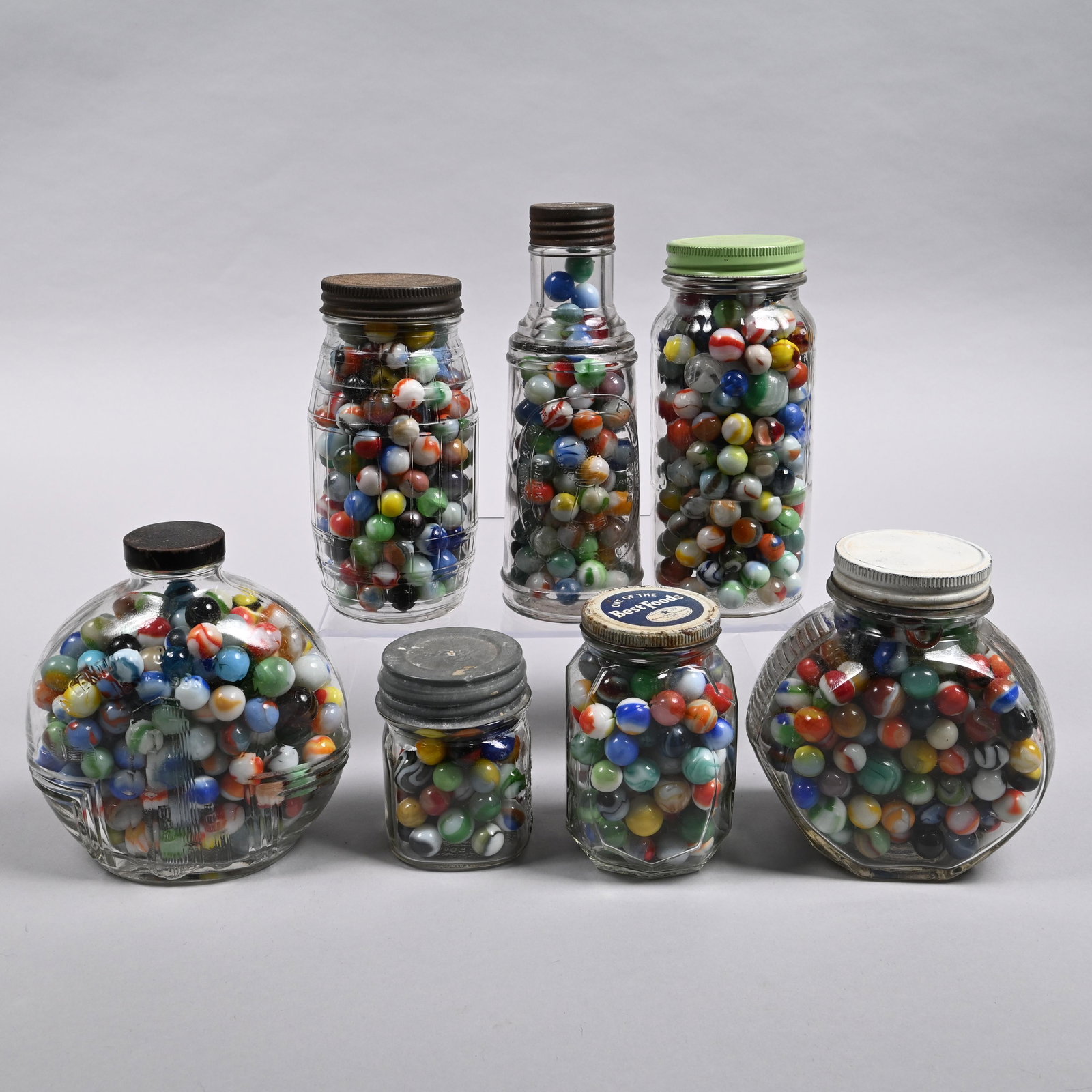 Seven Jars of Vintage Machine-Made Marbles: Tallest jar: H: 8.5 in., W: 3 in., D: 3 in.