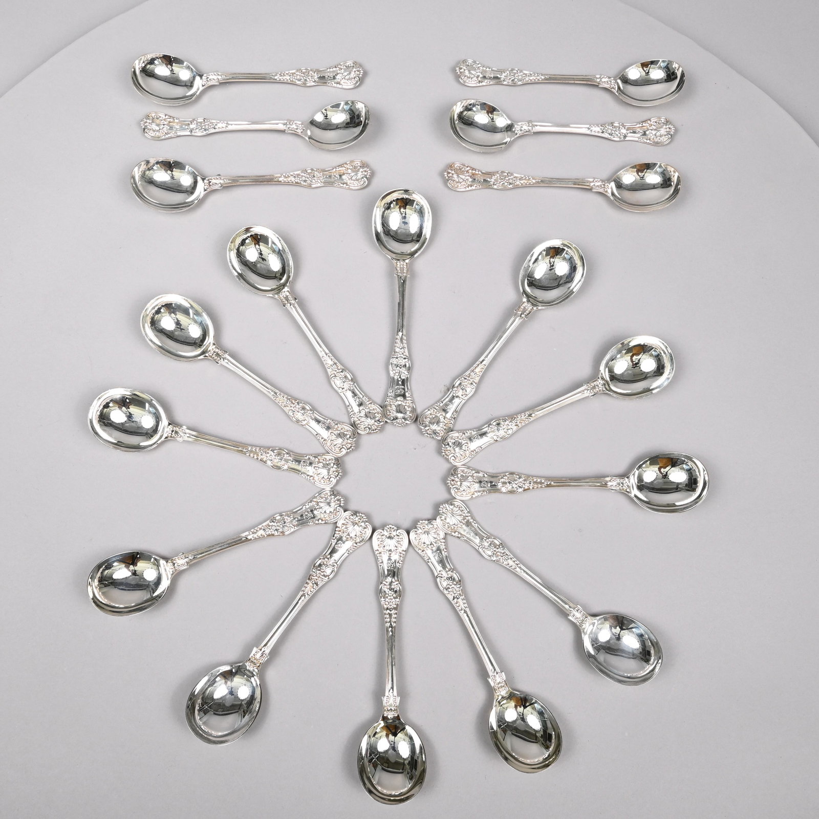 Set 18 Sterling Silver Gumbo Spoons, Tiffany & Co.: Set of Eighteen 'English King' Pattern Gumbo or Cream Soup Spoons, The Directorship of Edward Moore, 1873-1891, Designed by Charles T. Grosjean and Patented September 1, 1885. Each engraved with the i