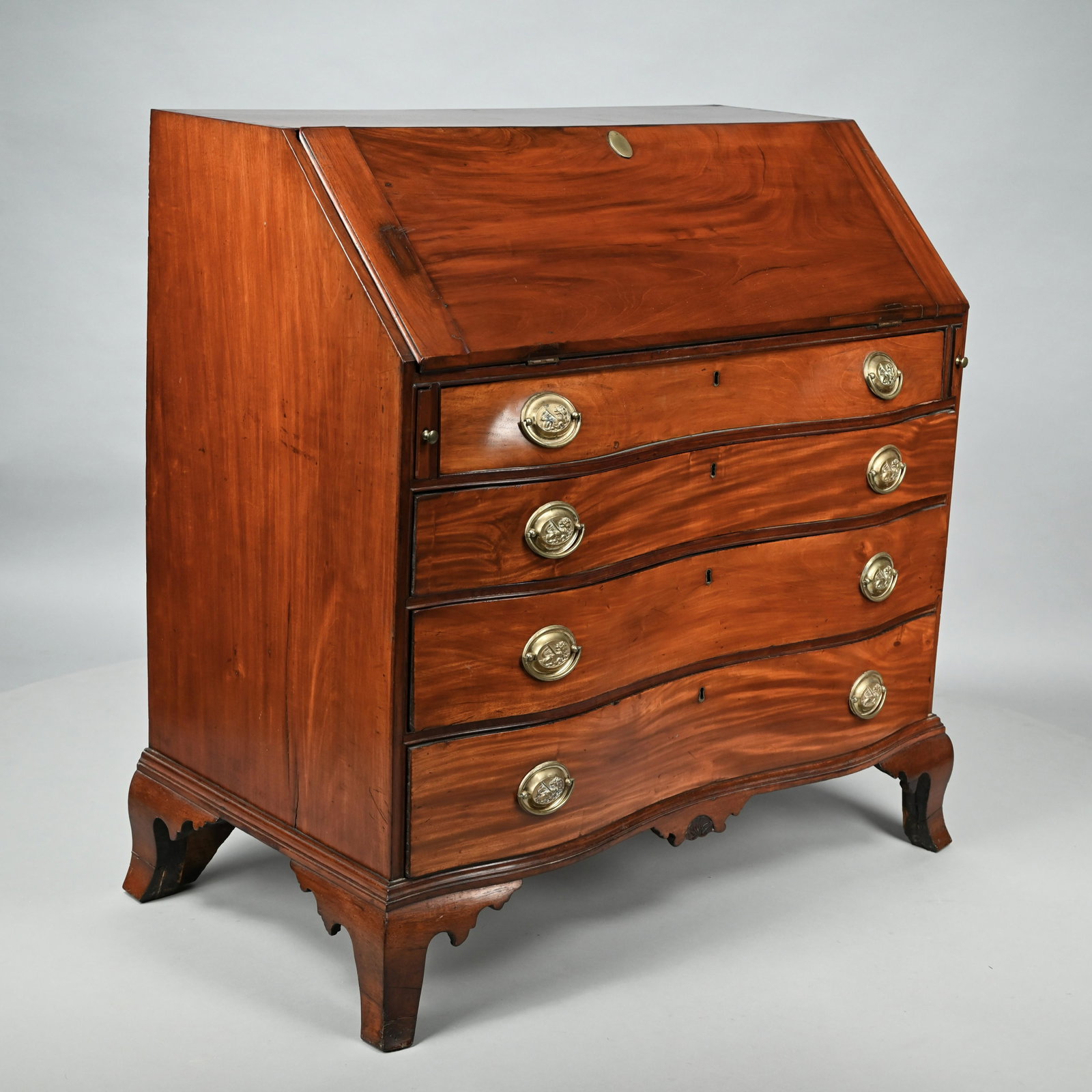 Salem, Mass. Chippendale Mahogany Desk, Circa 1770: The rectangular top above the slant-front opening to a series of drawers and cubby holes centering a prospect door, over the serpentine front fitted with four graduated drawers, the molded base center