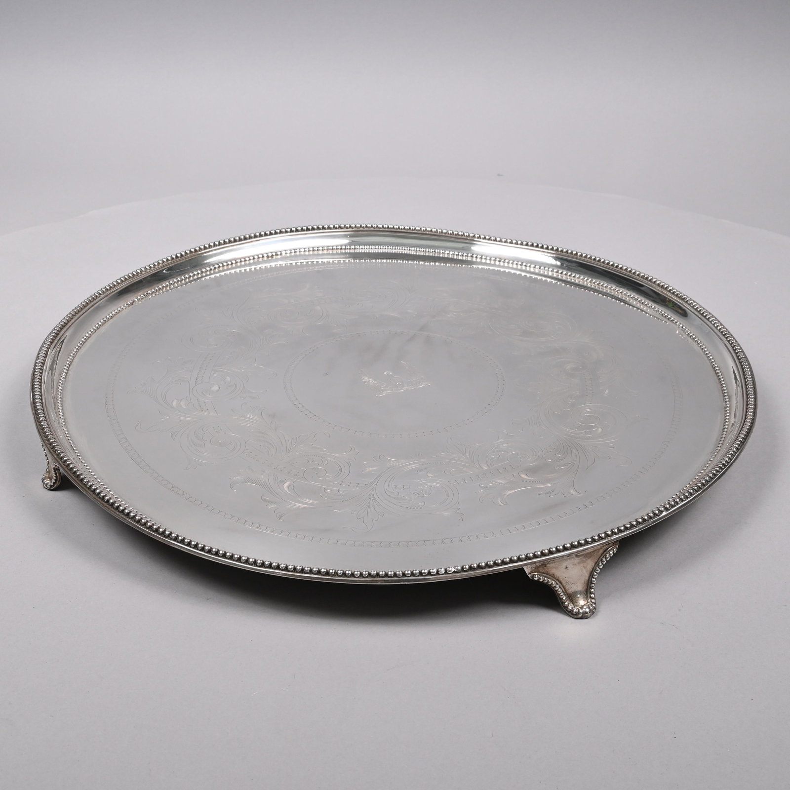 George III Sterling Silver Salver, John Sidaway: George III Sterling Silver Crested Salver, John Sidaway, London, 1781. Engraved in the center with the crest of a spur, rowelled and buckled, between two wings, surrounded by a wide band of scrolled a
