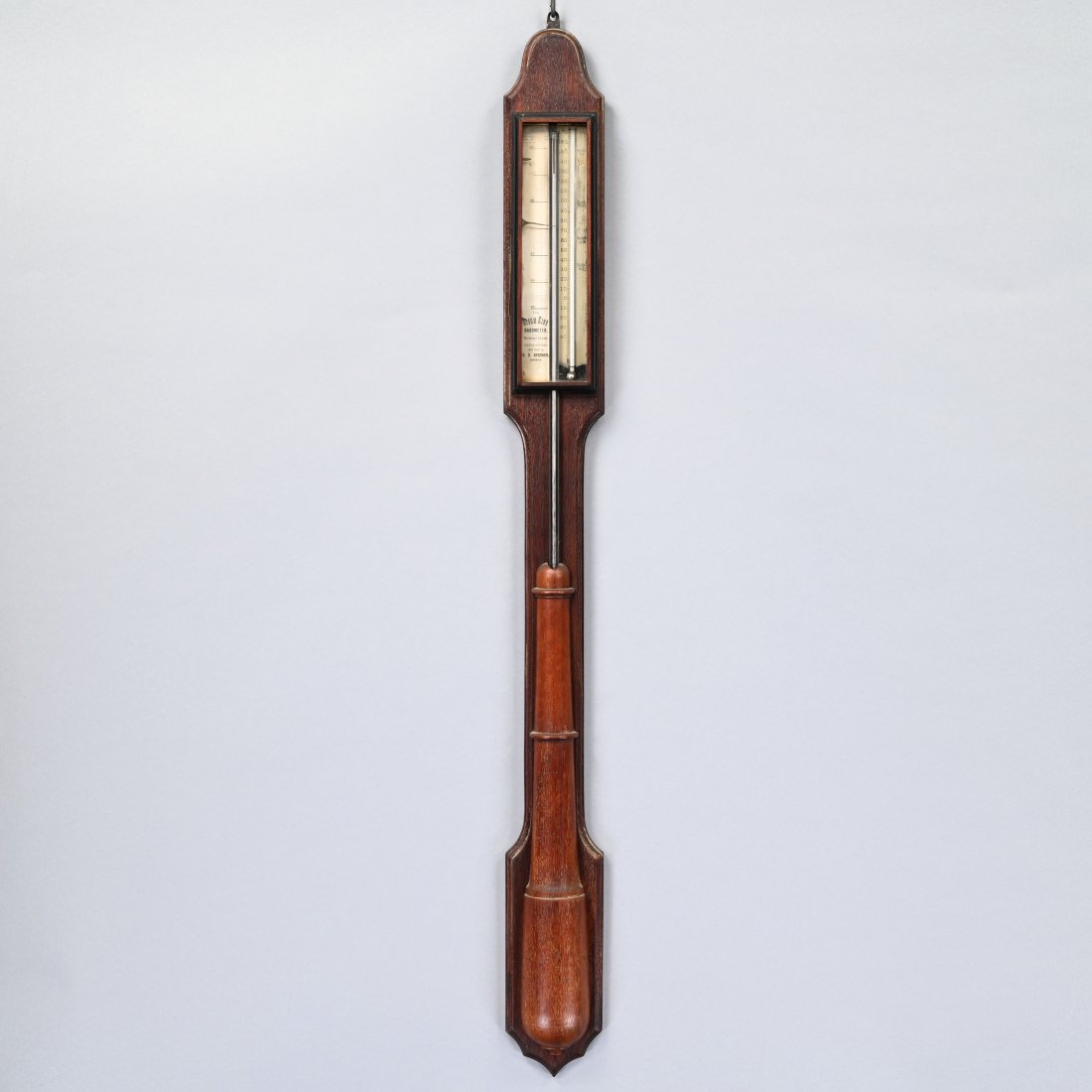 American Mahogany Stick Barometer: E.C. Spooner, Boston, "Storm King", Nineteenth Century. The arched crest above a glazed window with silvered dial inscribed "The Storm King Barometer. - Warranted Correct. - Manufactured And Sold by E