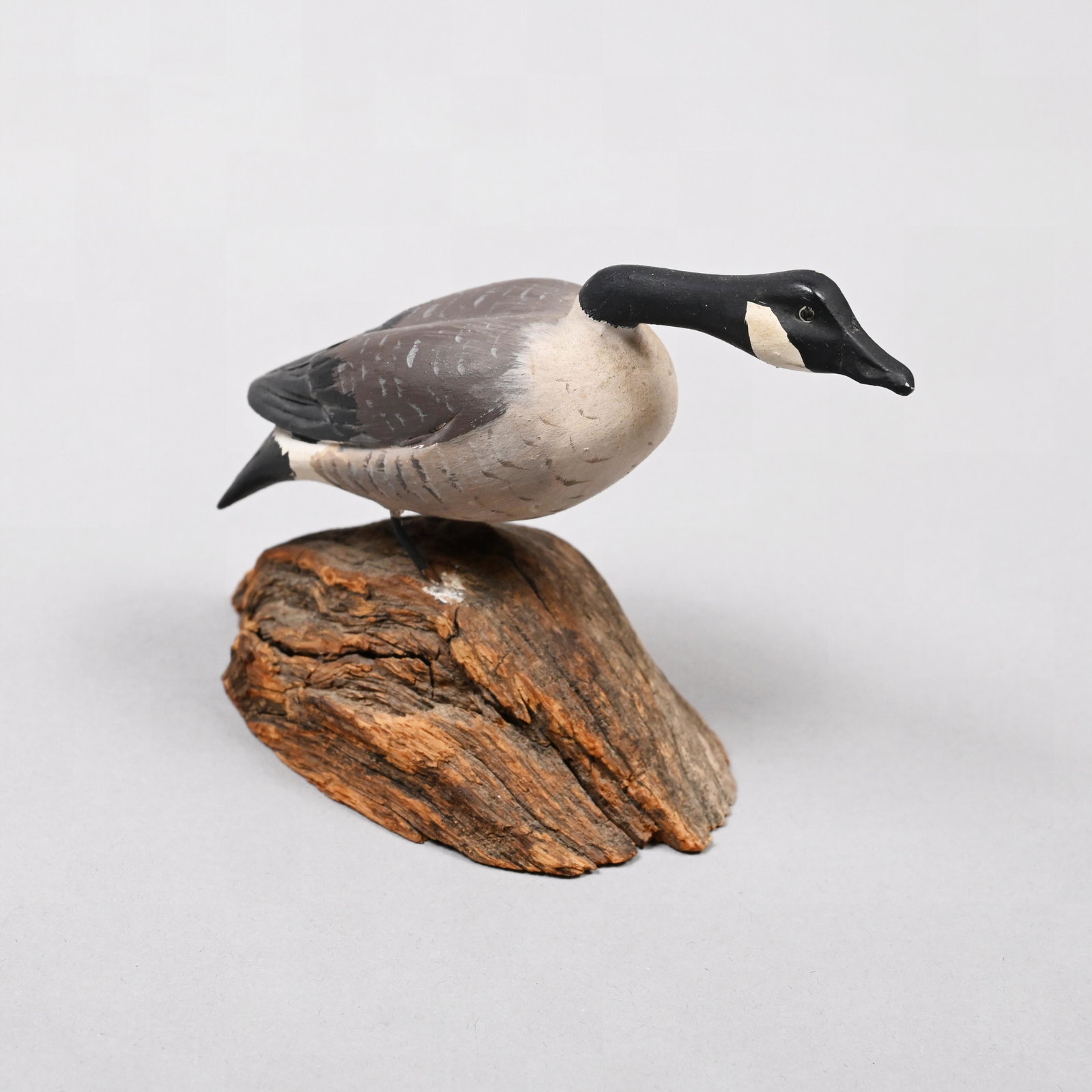 Russ Burr, Miniature Carved & Painted Canada Goose: Russell P. Burr (American, Hingham, MA, 1887-1955). Miniature Carved and Painted Hissing Canada Goose. Ink stamp "RUSS P. BURR/ HINGHAM, MASS." H: 3.25 in., W: 5 in., D: 2.25 in.