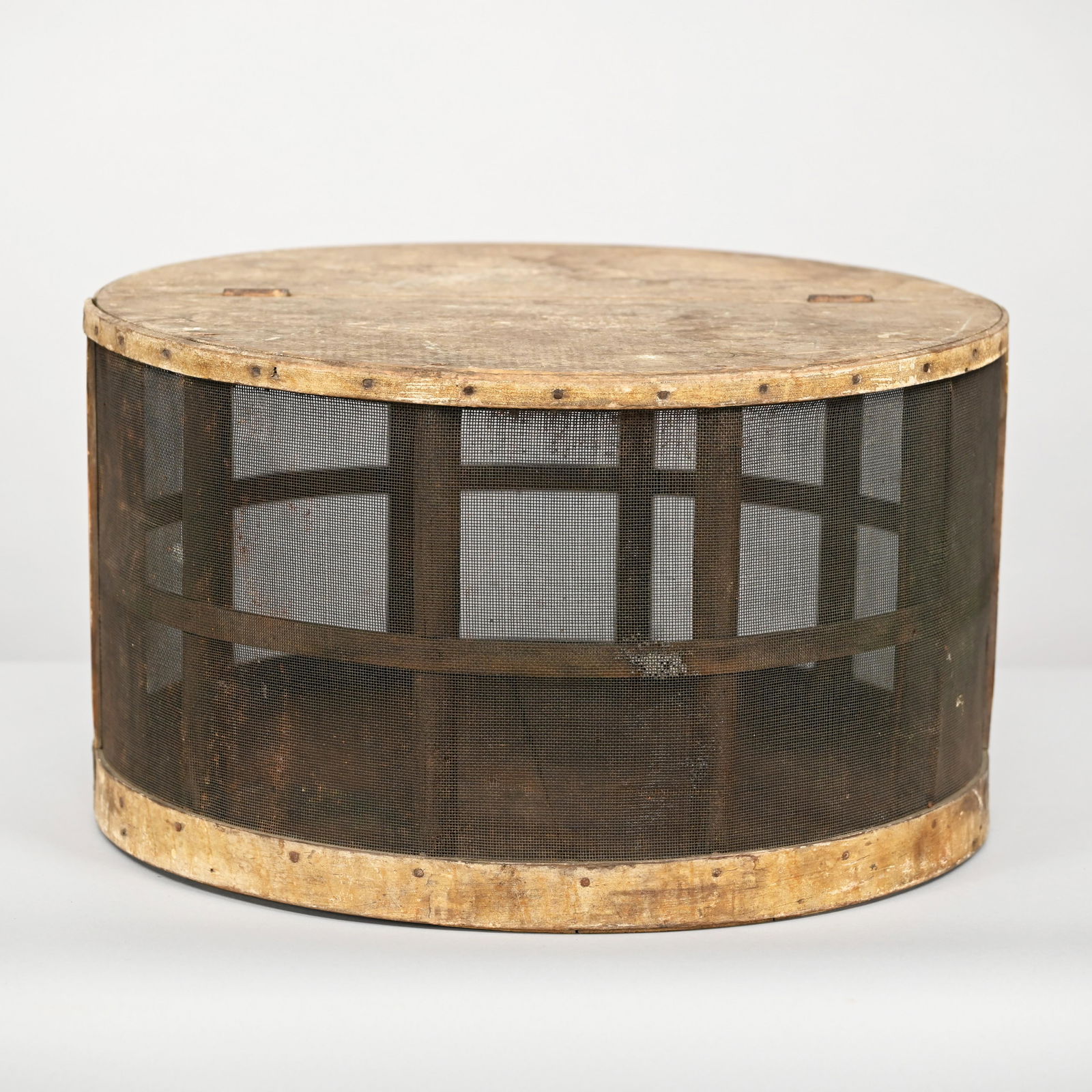 American Pine & Mesh Country Store Cheese Safe: Of circular form, the hinged cover and one side opening to the interior, including a primitive wirework cheese holder. H: 12.25 in., Diam: 21.25 in.
