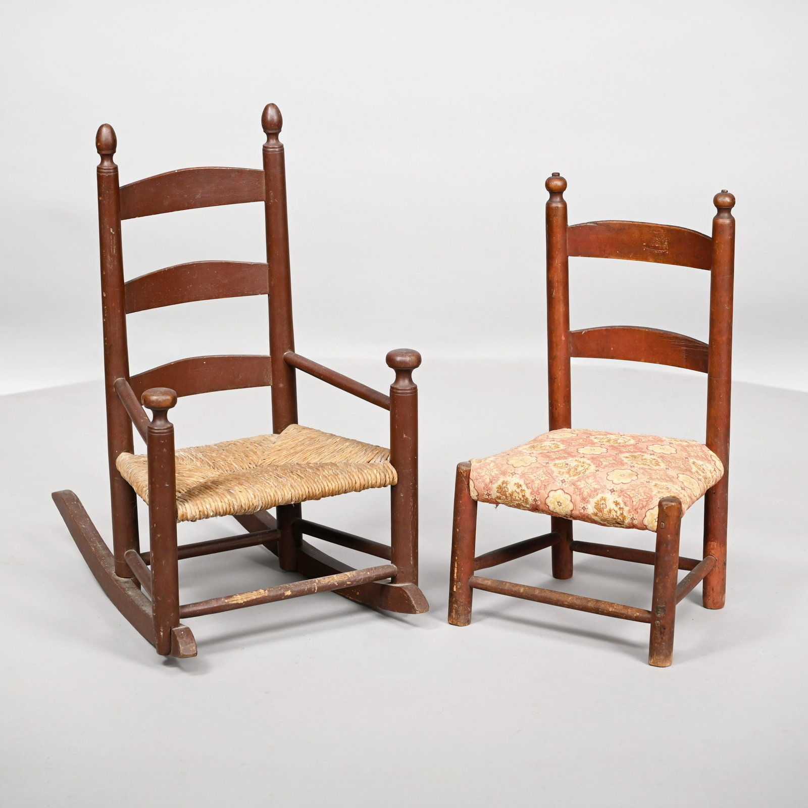 Amer. Child's Ladderback Rocking Chair &Side Chair: Both in brown paint. Ladderback rocking chair: H: 26.5 in., W: 16 in., D: 23 in. Side chair: H: 22.75 in., W: 13 in., D: 10.75 in.