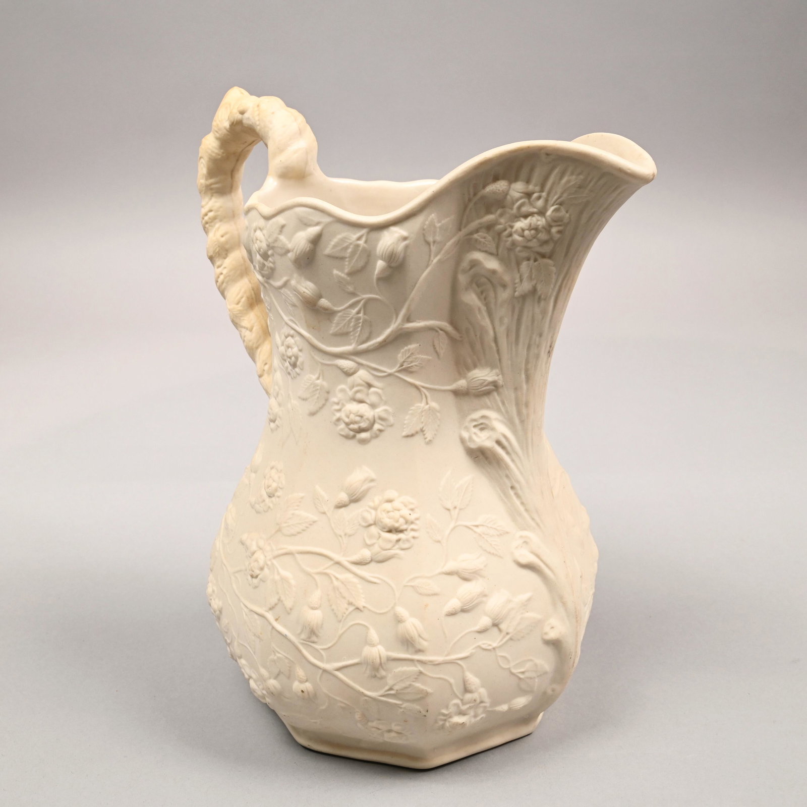 Bennington Parian 'Wild Rose' Pitcher, 1845-47: Of baluster form with eight-panel sides, molded in relief with trailing rose vines, the interior glazed, unmarked. H: 10 in., W: 7.75 in., D: 6.5 in.