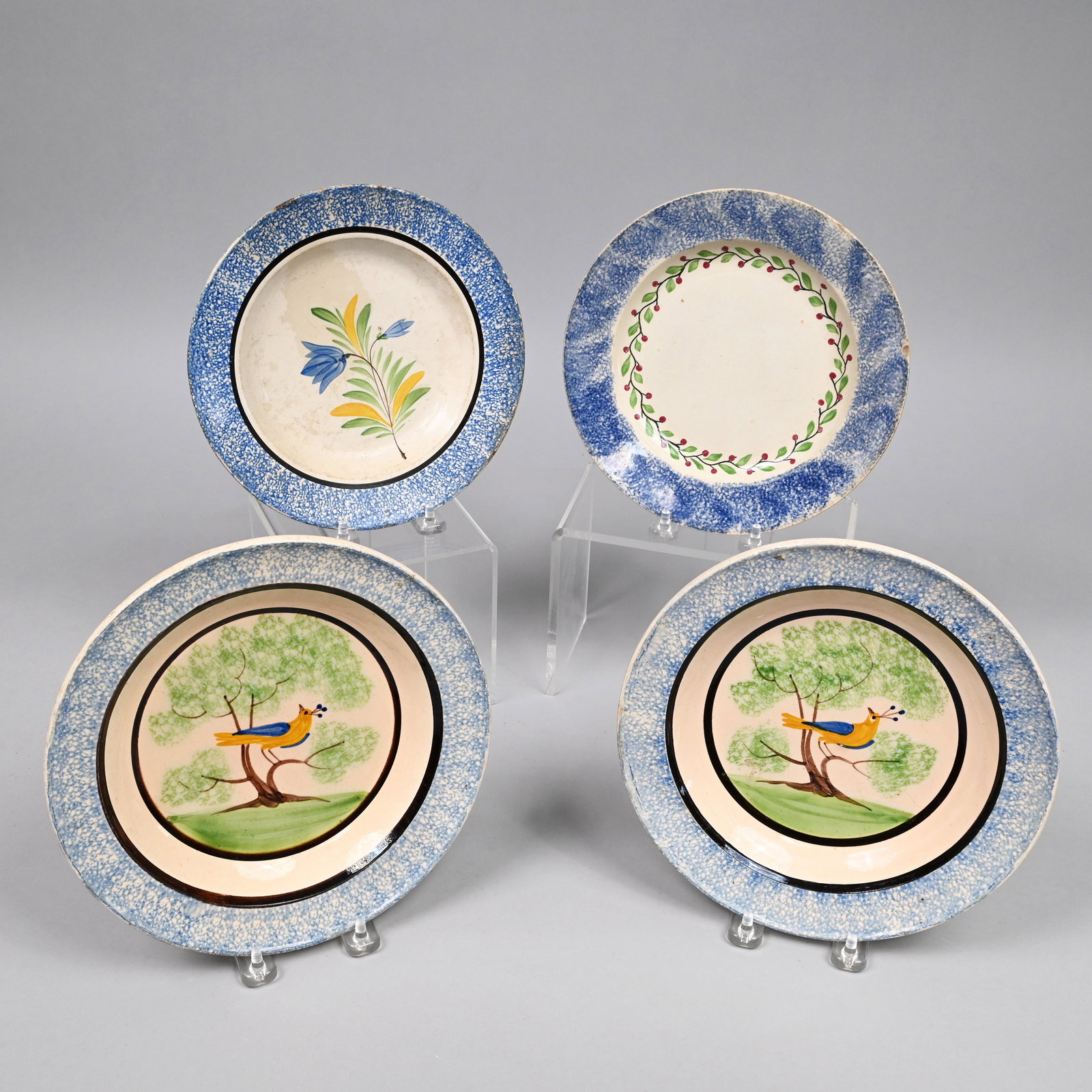 Pair Staffordshire Spatterware Peafowl Bowls: Pair of Staffordshire Spatterware 'Peafowl' Bowls, 1820-30. Each painted in the center with a bird in blue and yellow plumage and with topknot of feathers, perched in a sponged tree on a grassy knoll,