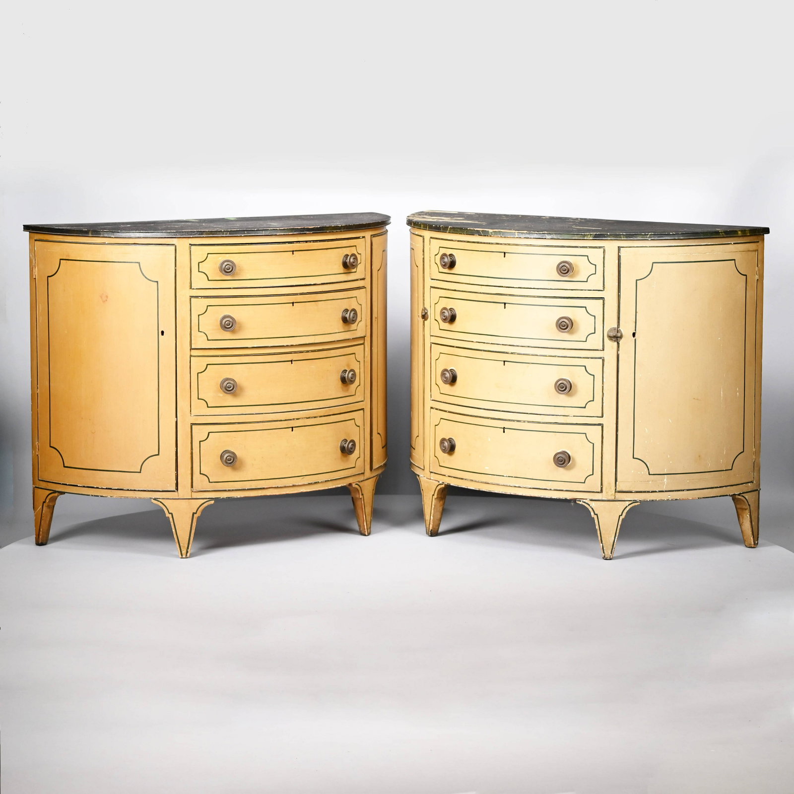 Pair of Louis XVI Painted Demilune Console Tables: Pair of Louis XVI Painted Wood Demilune Console Tables. Each in ochre paint, the yellow-veined black faux marbre top above four drawers outlined in black and with brass pulls, raised on tapered feet.