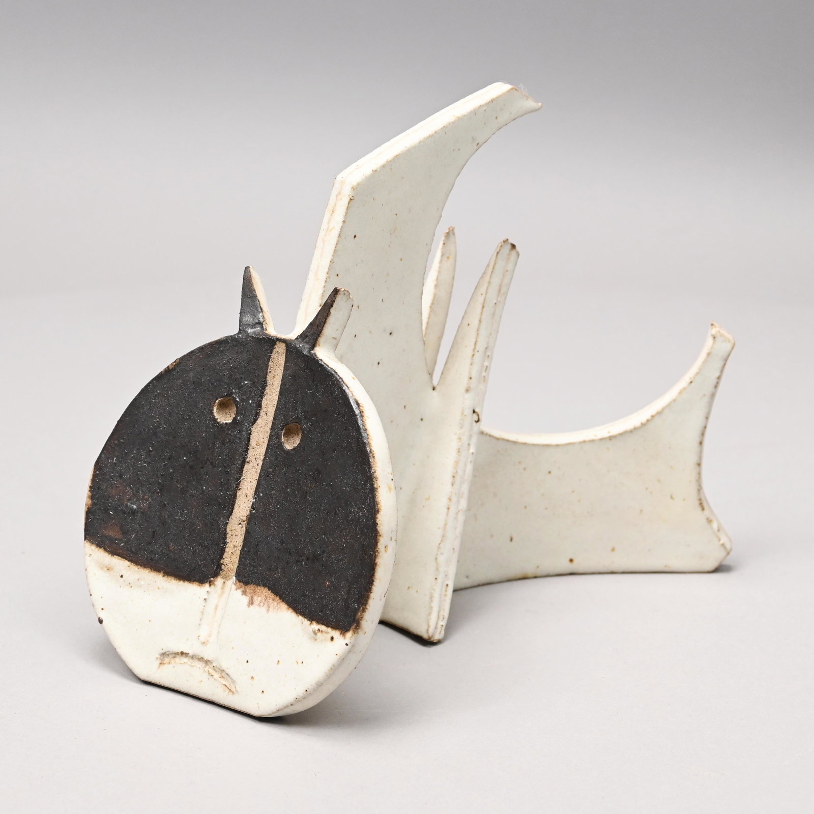 Bruno Gambone - Glazed Stoneware "Cat" Sculpture: Bruno Gambone (Italian, 1936-2021). From the "Animali Fantastici" Series: Stoneware Figure of a Semi-Circular "Cat," Early 1970's-1990's. Modelled, incised and covered in speckled matte cream glaze, w