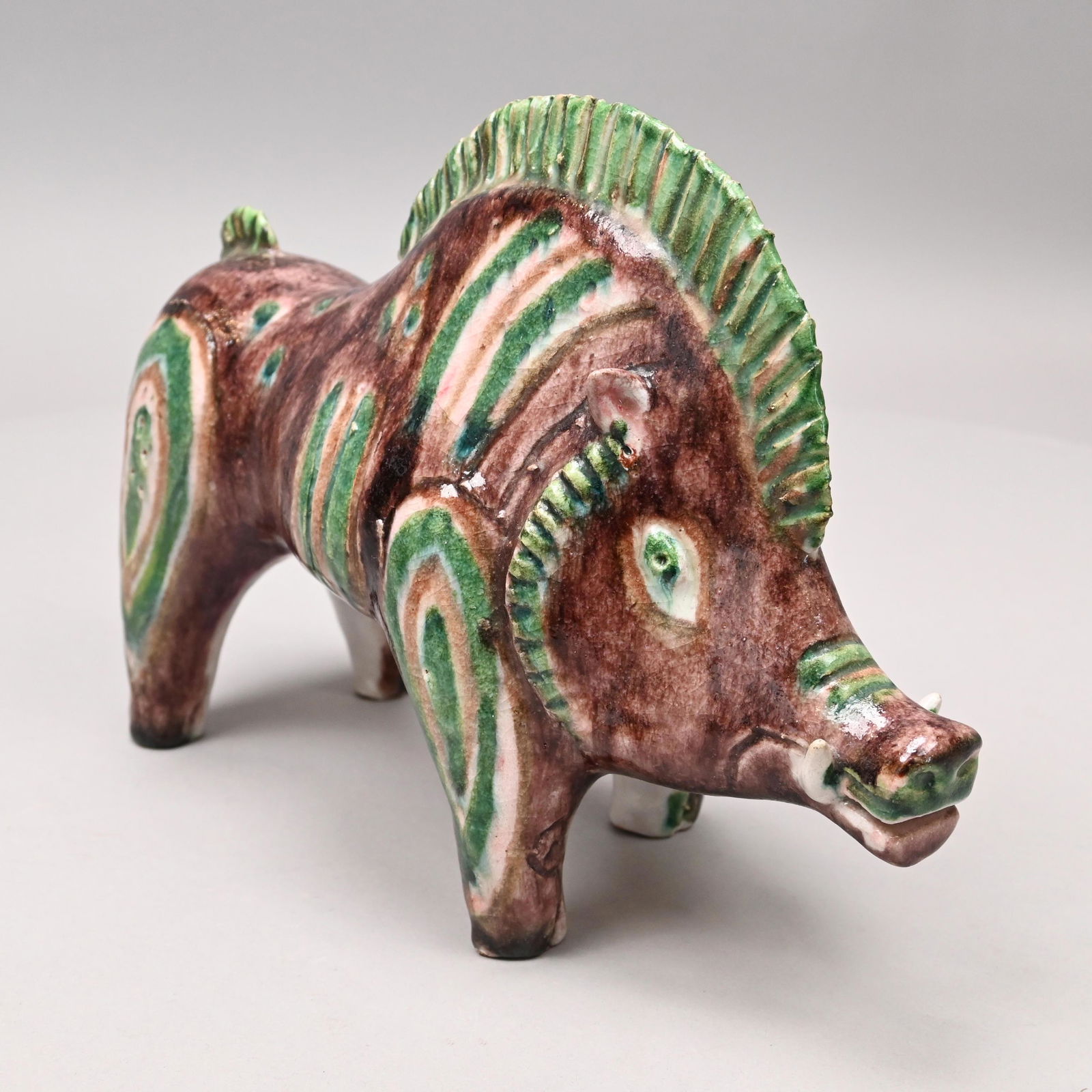 Guido Gambone - Glazed Pottery Wild Boar: Guido Gambone (Italian, 1909-1969). Glazed Pottery Figure of a Wild Boar, 1950's-1960's. Covered in purple glaze heightened in dark green and taupe with stripes, dots and concentric patches, painted w