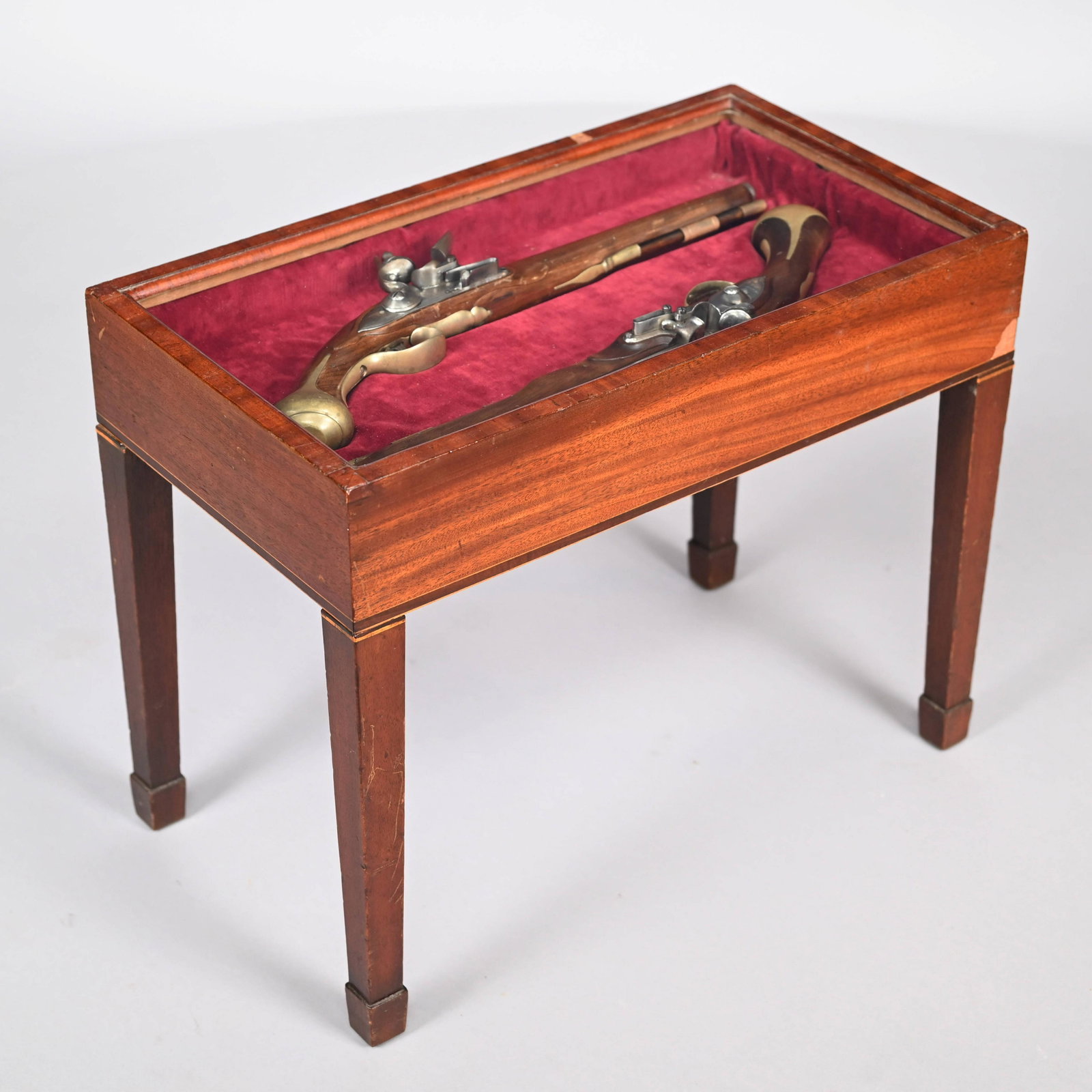 Pair Cased Wilets British Dragoon Pistol Replicas: Pair of Wilets British Dragoon Pistol Replicas, Encased in a Regency Style Glazed Mahogany Stand. Comprising a pair of accurately reproduced Colonial Williamsburg flintlock pistols, each with walnut g