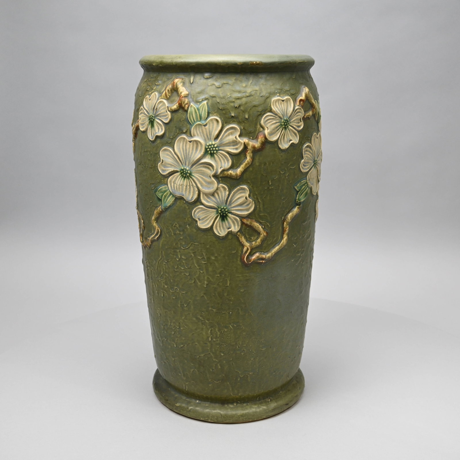 Roseville Pottery "Dogwood I" Umbrella Stand: Roseville Pottery Company 'Dogwood I' Umbrella Stand, Zanesville, Ohio, Introduced in 1918. Painted "L. Rv" ink stamp in underglaze-blue, numeral "766" in brown crayon. H: 20.5 in., Diam: 10.5 in.