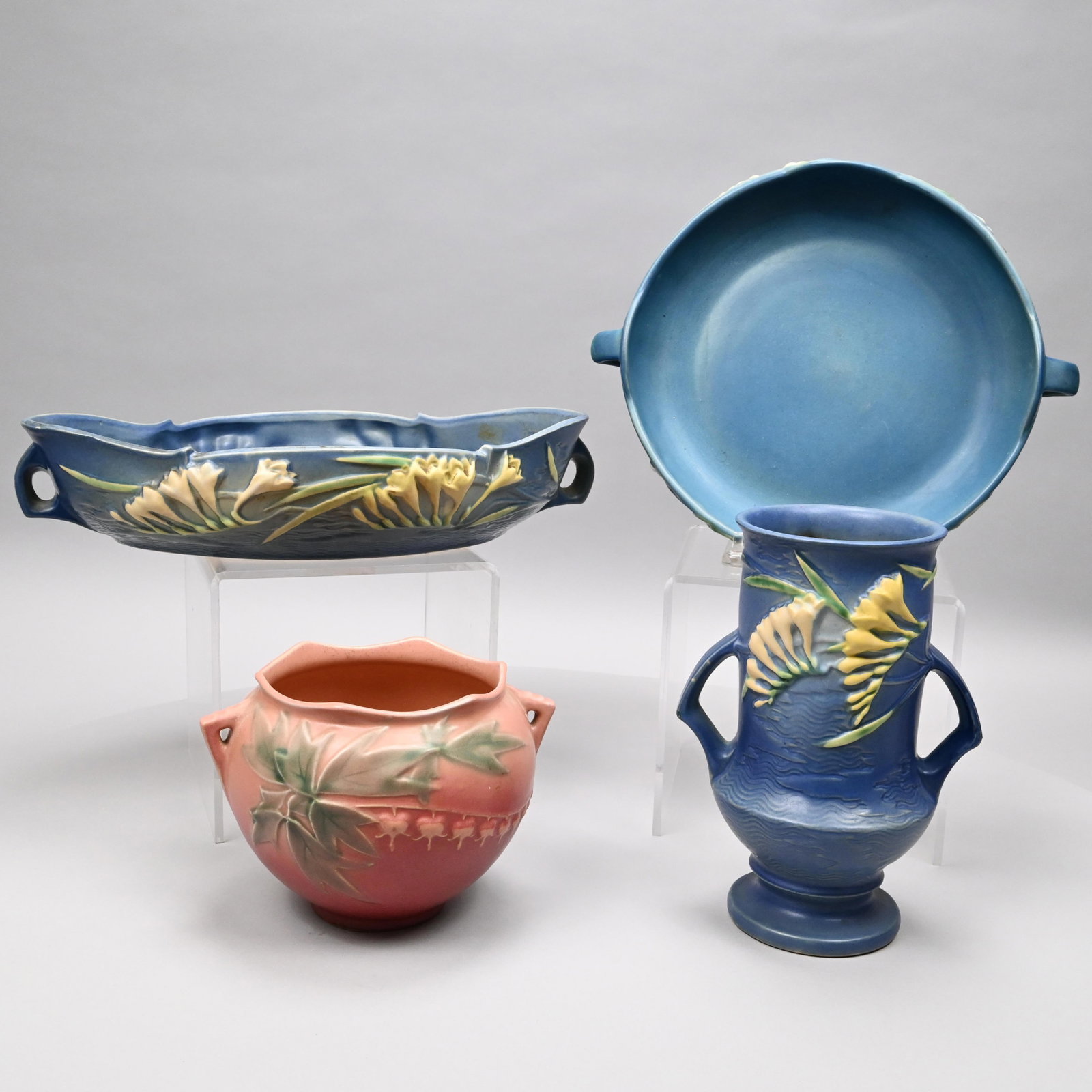 Four Roseville Pottery Wares, 1938-1946: Four Roseville Pottery Wares, 1938-1946. Comprising a 'Bleeding Heart' #651-5 jardiniere, introduced in 1938, in pink glaze; a ''Freesia' #123-9 vase and a #469-14 console bowl, introduced in 1945, in